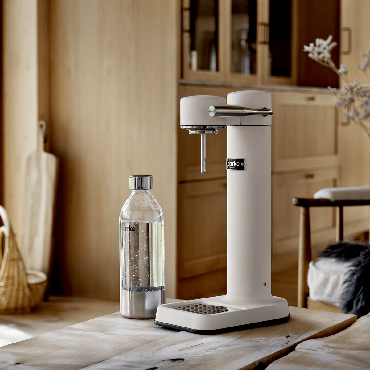 Close up of stylish sparkling water maker designed by Aarke in Sweden showing the matte white finish and displayed on the kitchen cabinet