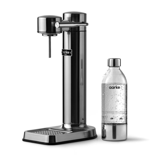 Stylish sparkling water maker designed by Aarke in Sweden showing the stainless steel finish and the included 650ml PET water bottle