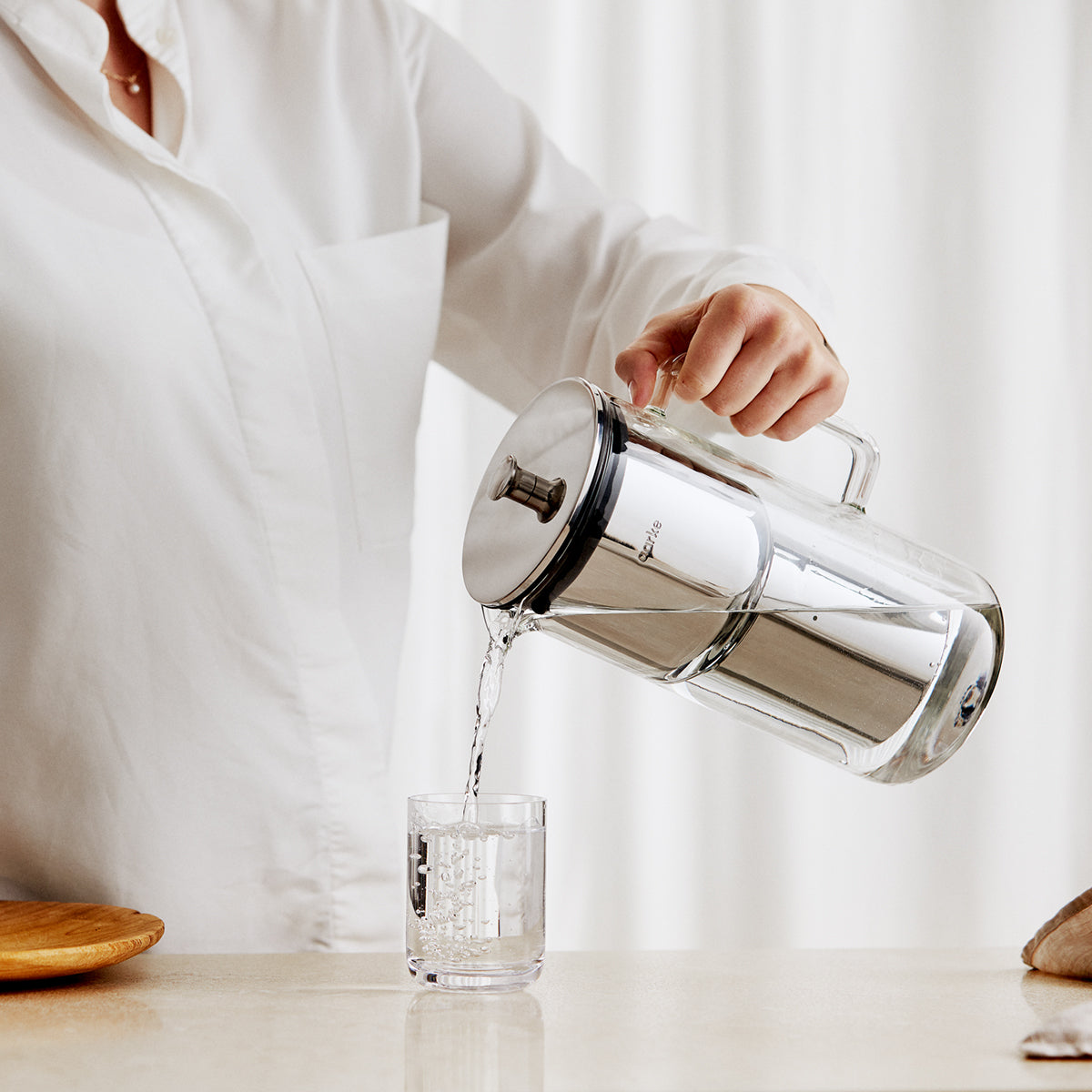 Serving water using the water purifier jug designed by Aarke in Sweden