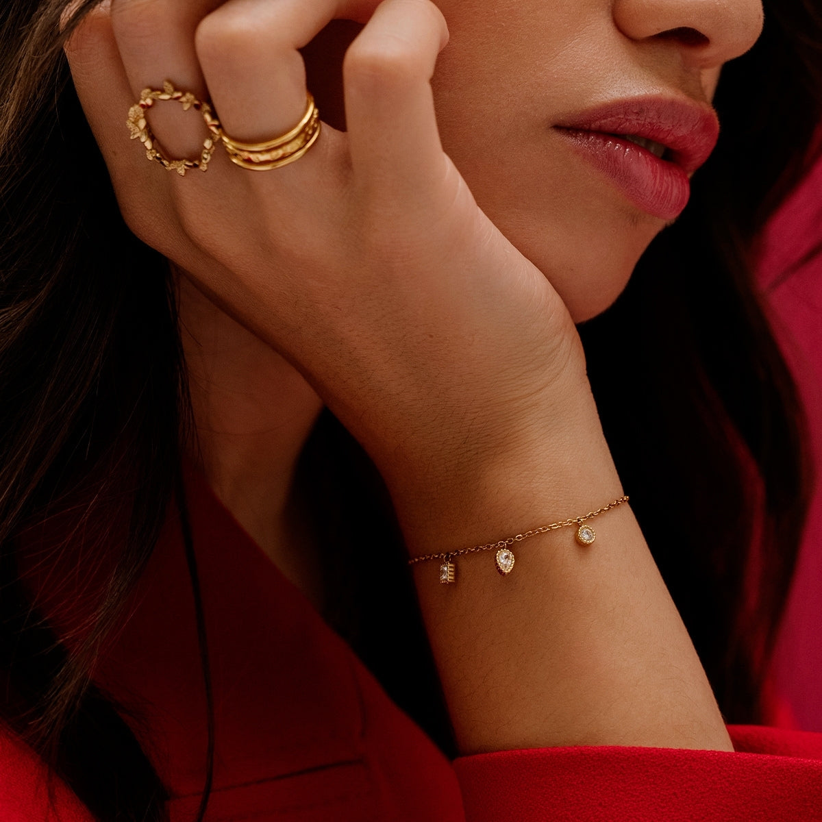 Showing a woman wearing on her wrist with the three pendants from AEC Paris Anya White Zirconium Oxide bracelet - 3-stone droplet bracelet with white cubic zirconia on 14k gold-plated stainless steel, hypoallergenic and durable everyday jewellery, minimalist elegant design.