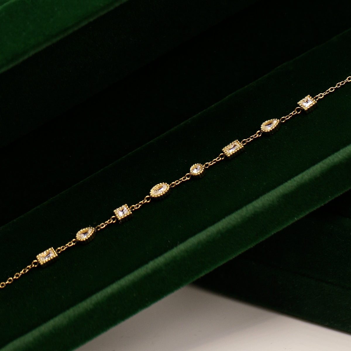 On its case the full view of its stations from AEC Paris Nila bracelet - gold multi-stone station bracelet in 14k gold-plated stainless steel, polished gold colour material featuring white cubic zirconia stones for a sparkling, elegant finish.