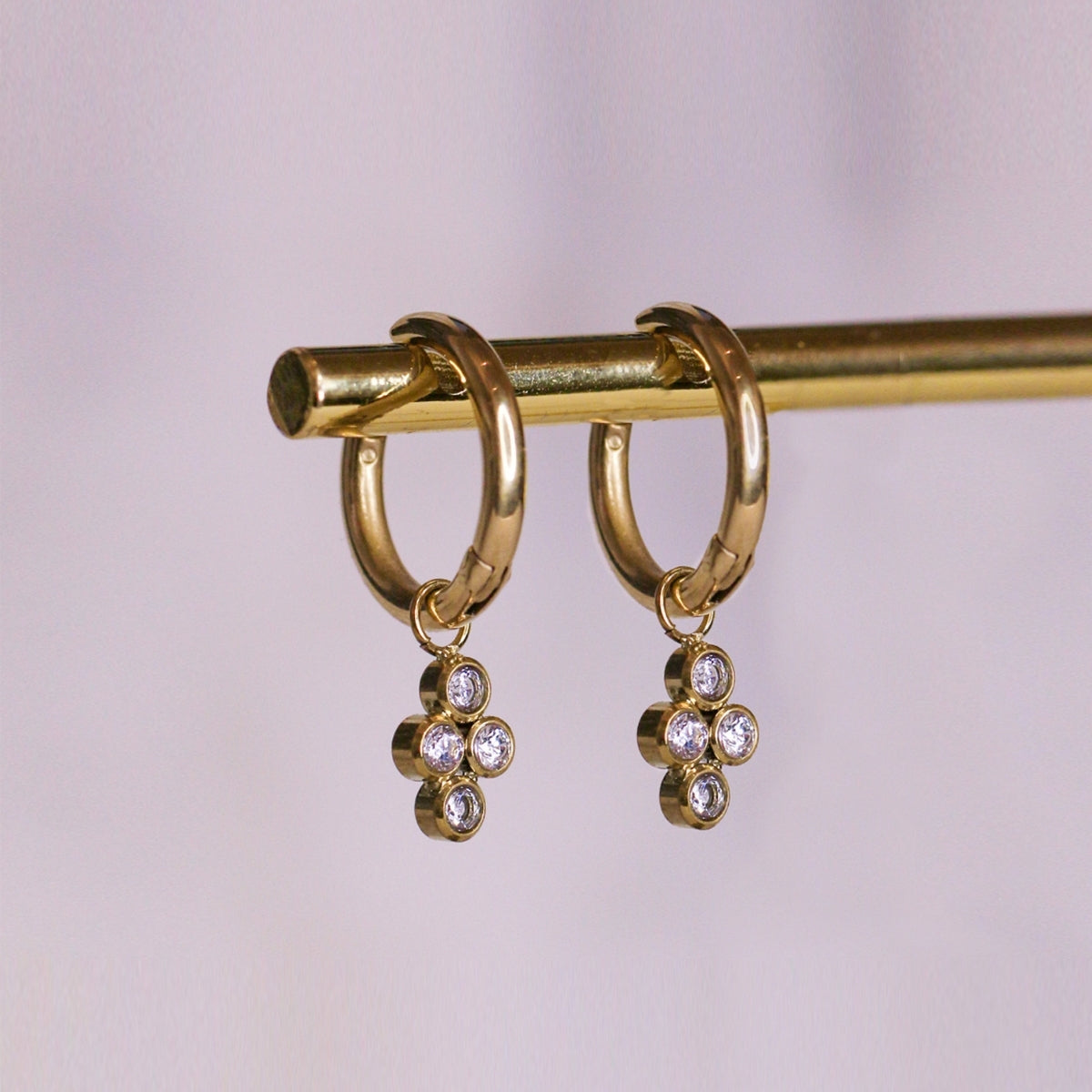 AEC Paris Bendis teardrop white-zirconium oxide earings hanging on brass rod