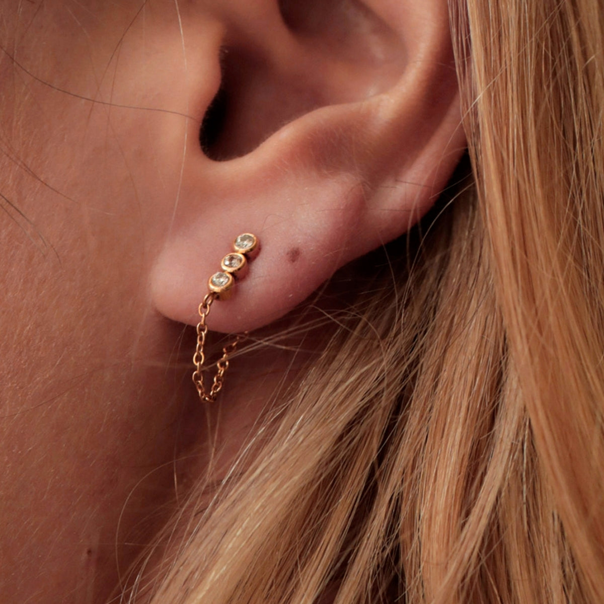 Close up of woman wearing AEC Paris Leto Aventurine stud earrings 