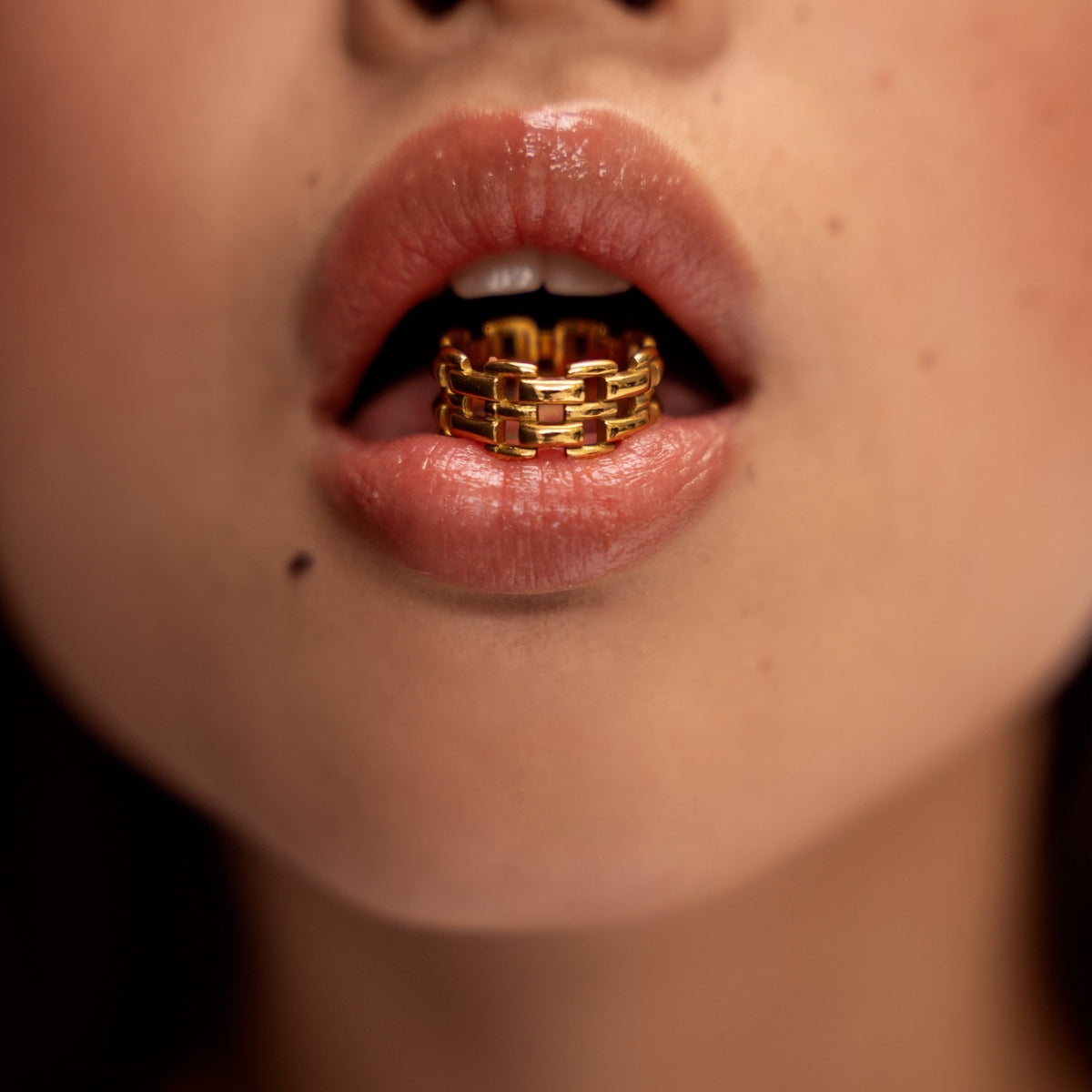 Woman with AEC Paris Elisa Gold size 7 ring in her mouth 