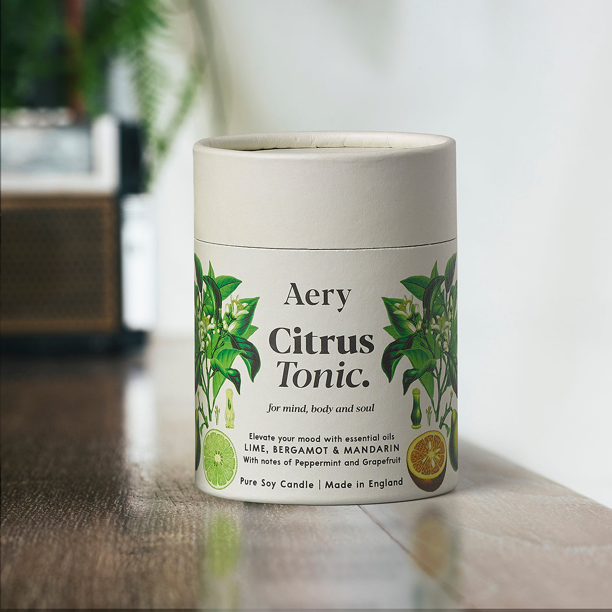 Aery Citrus Tonic 200gm candle from the Botanical Collection showing candle and packaging on wooden table