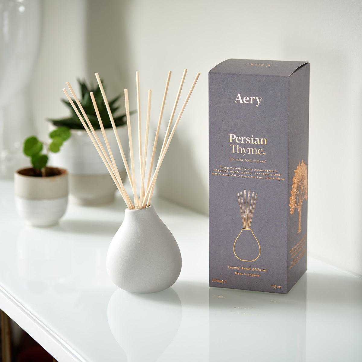Aery Persian Thyme 200ml diffuser from the Fernweh collection showing diffuser and packaging on white shelf with succulents
