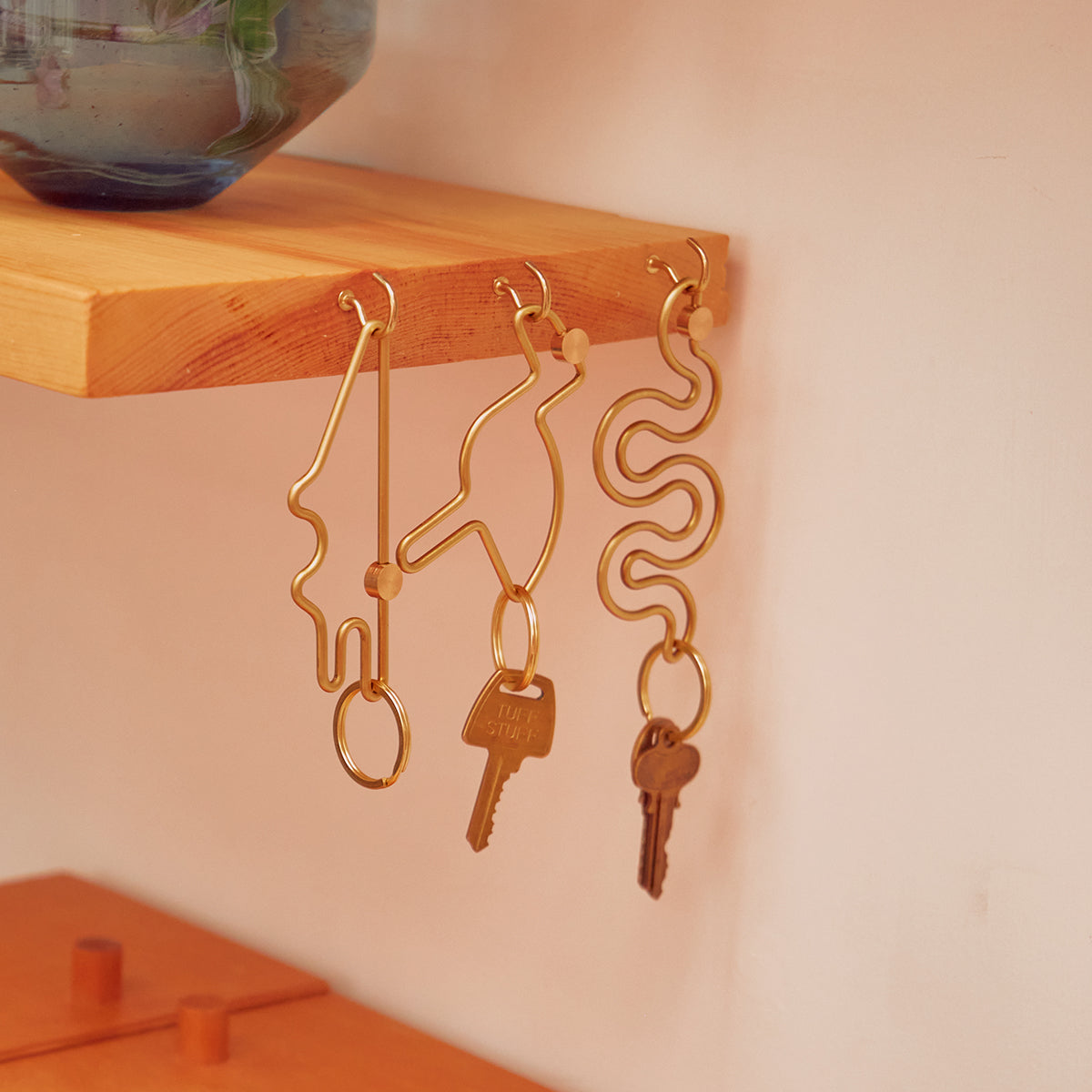 Areaware bird animal keyring hanging in a row of 3 keyrings