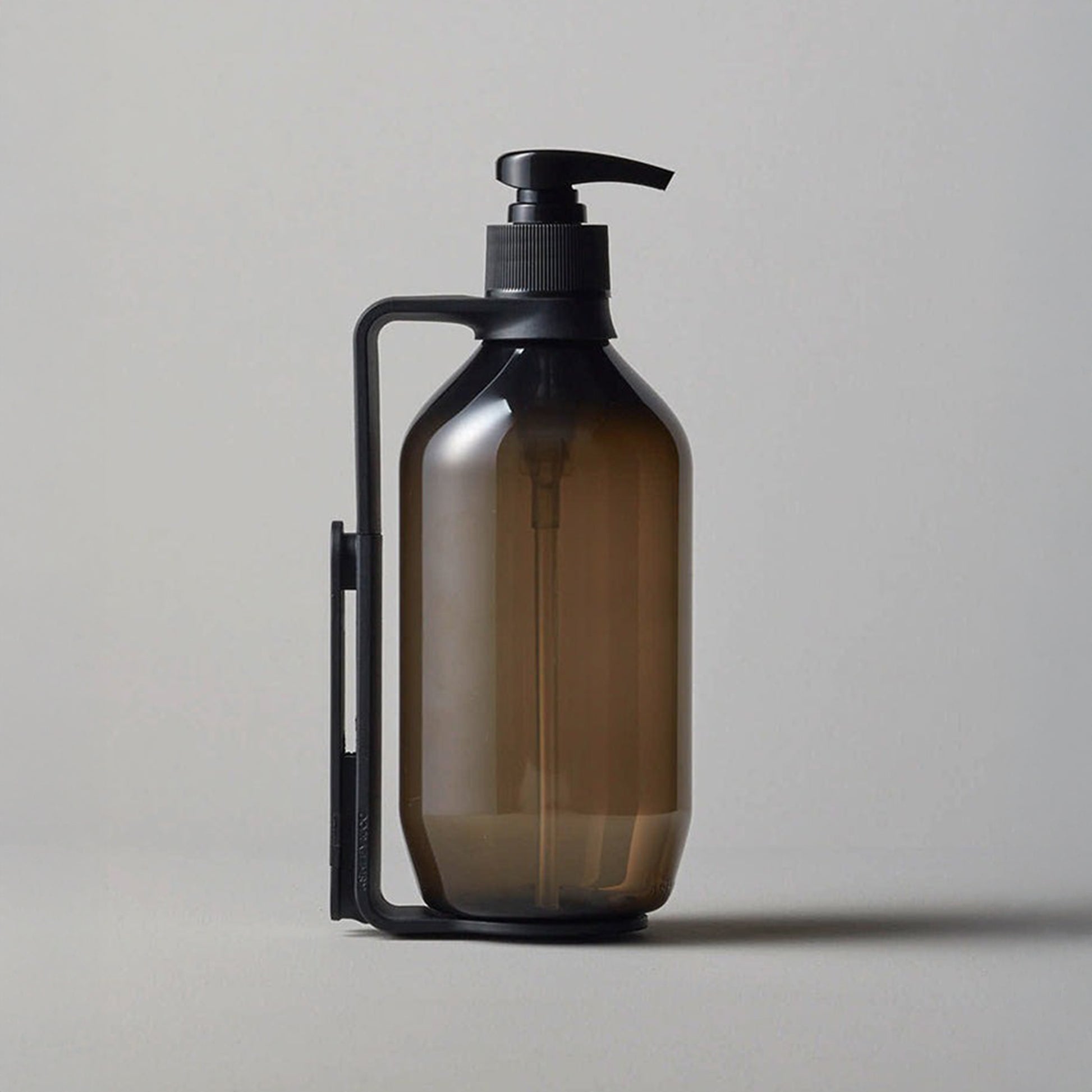 Ashley and Co 'hold me' wallmount shown from the side holding a bottle.