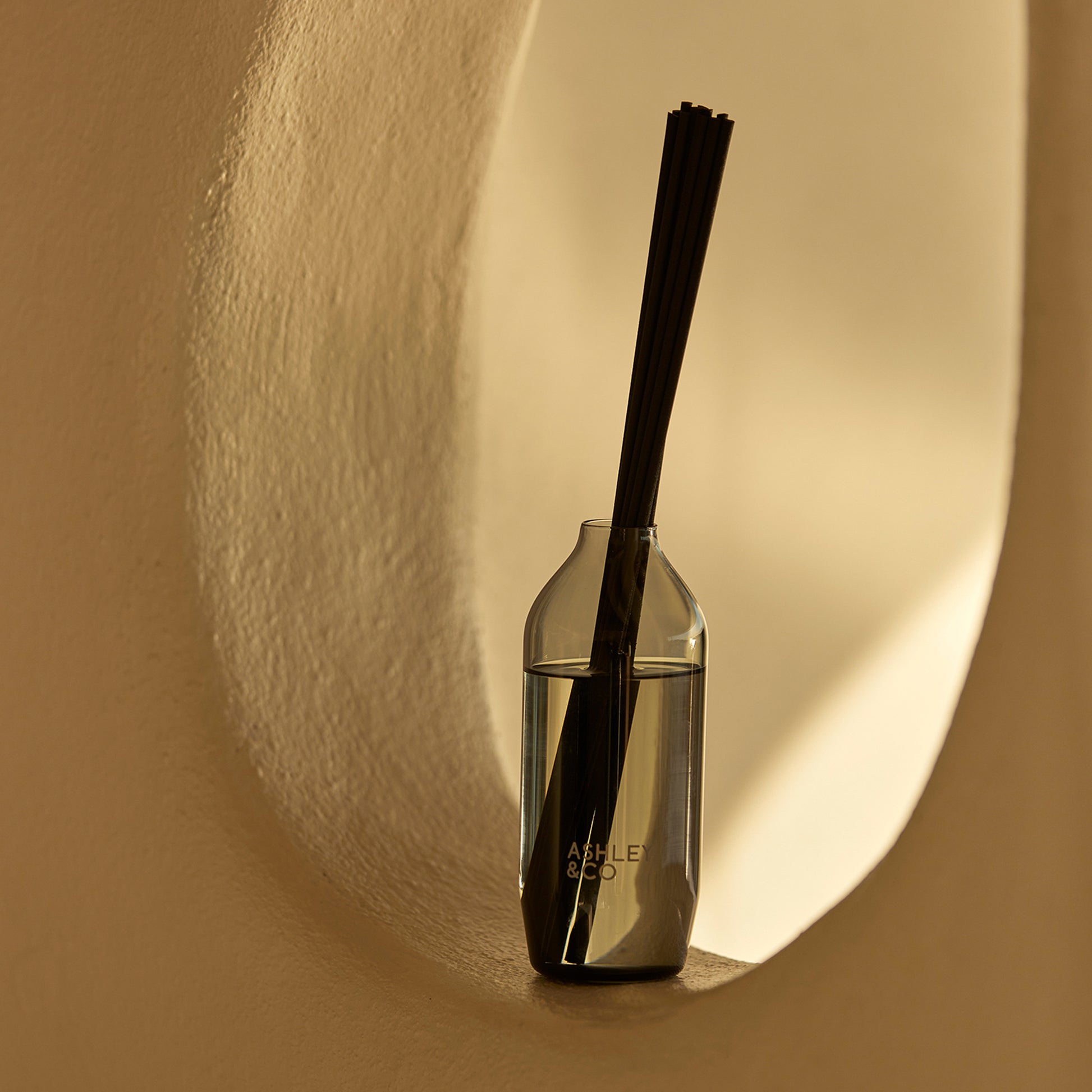 Ashley and Co 'Home Perfume' scent diffuser in blossom and gilt fragrance placed in a nook.