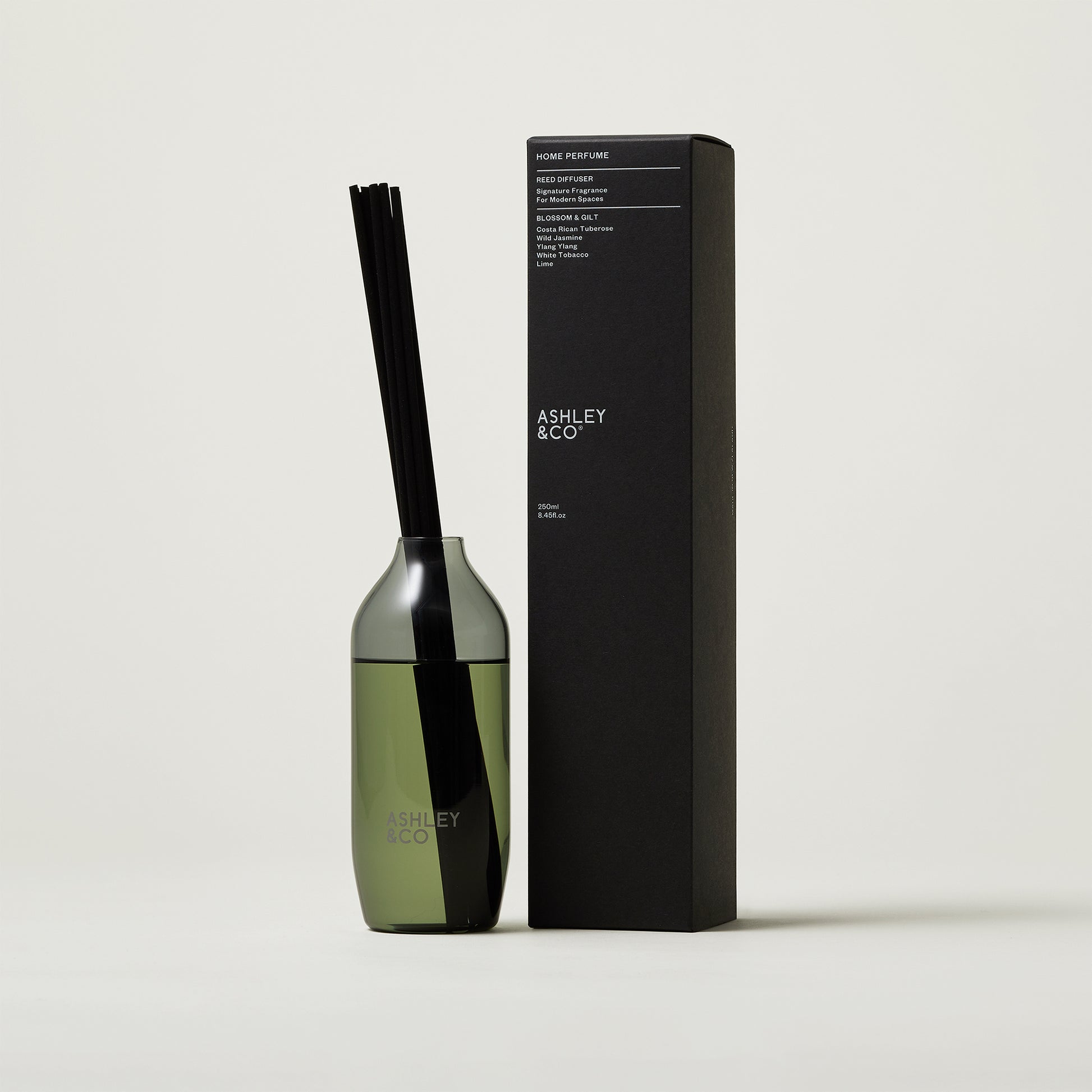 Ashley and Co 'Home Perfume' scent diffuser in blossom and gilt fragrance on a grey background.