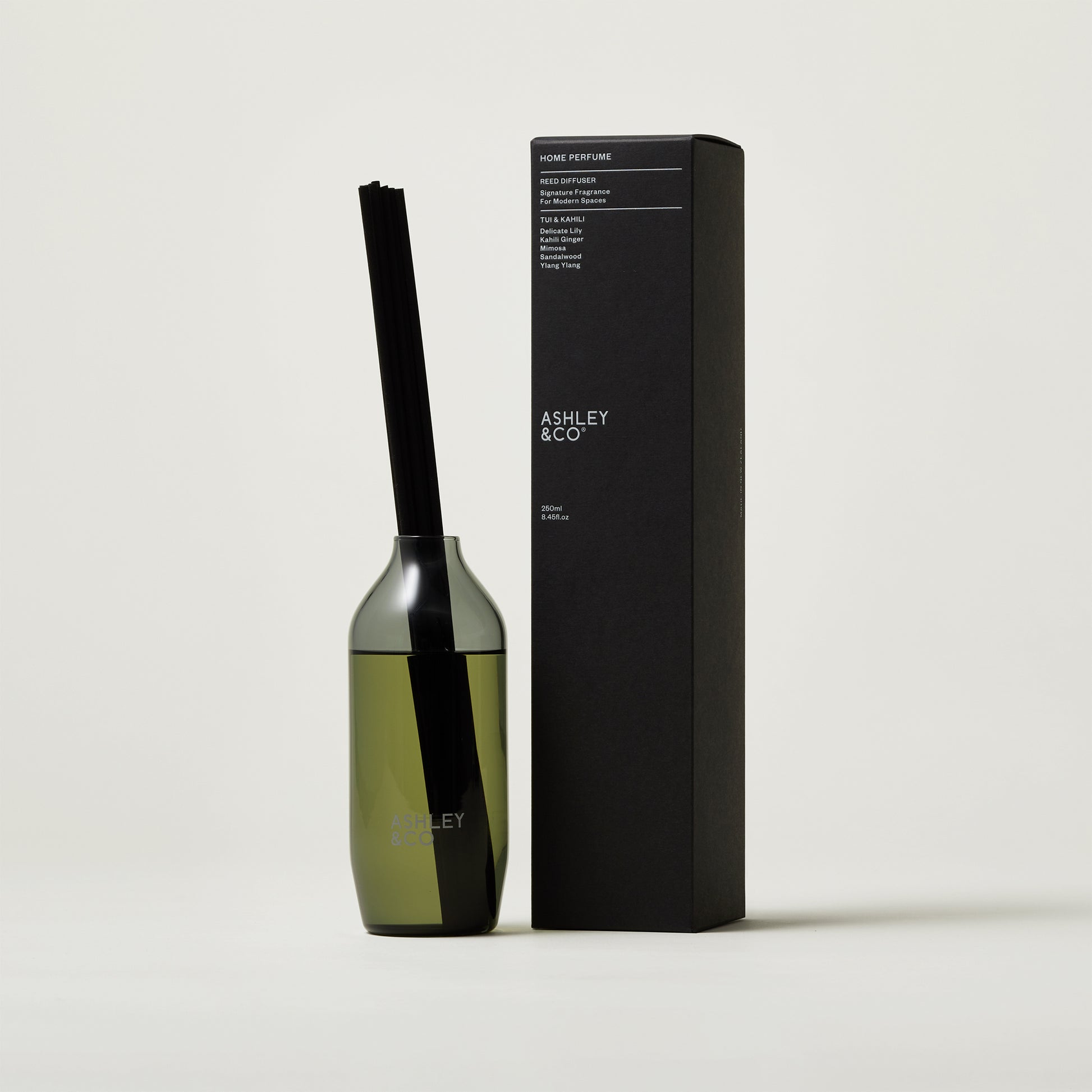 Ashley and Co 'Home Perfume' scent diffuser in tui and kahili fragrance on a grey background.