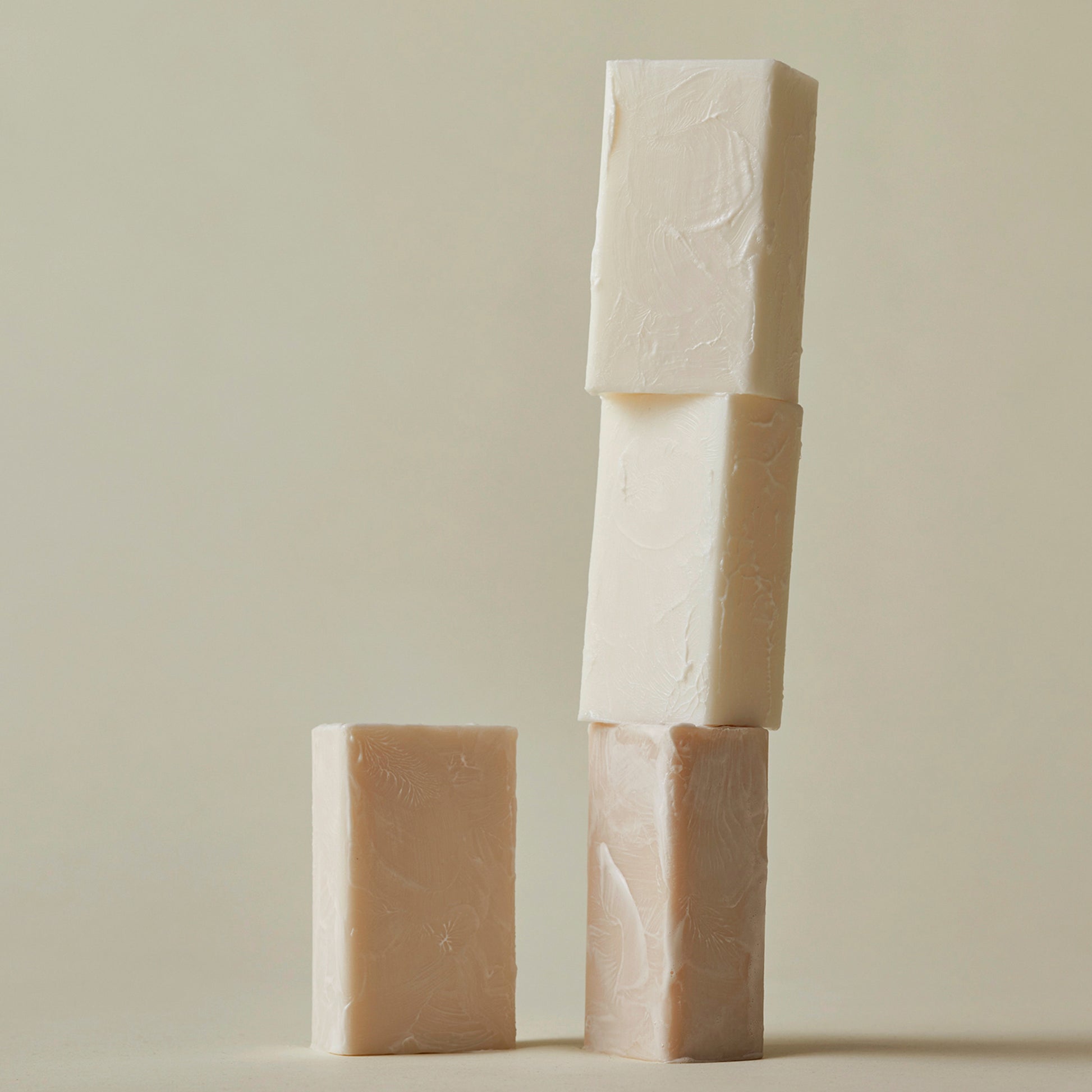 A stack of Ashley and Co 'Mini Bar' body soaps including Blossom and gilt fragranced soap.