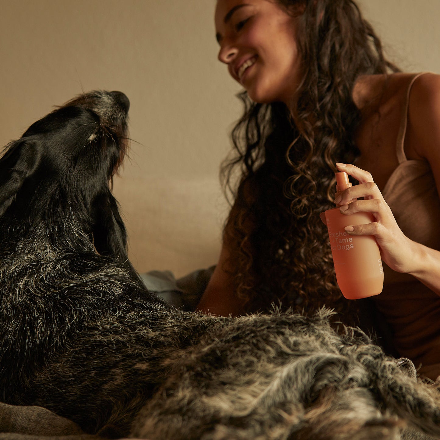 Ashley and Co 'Ruff Star' dog spray being sprayed onto a dog by a young woman.