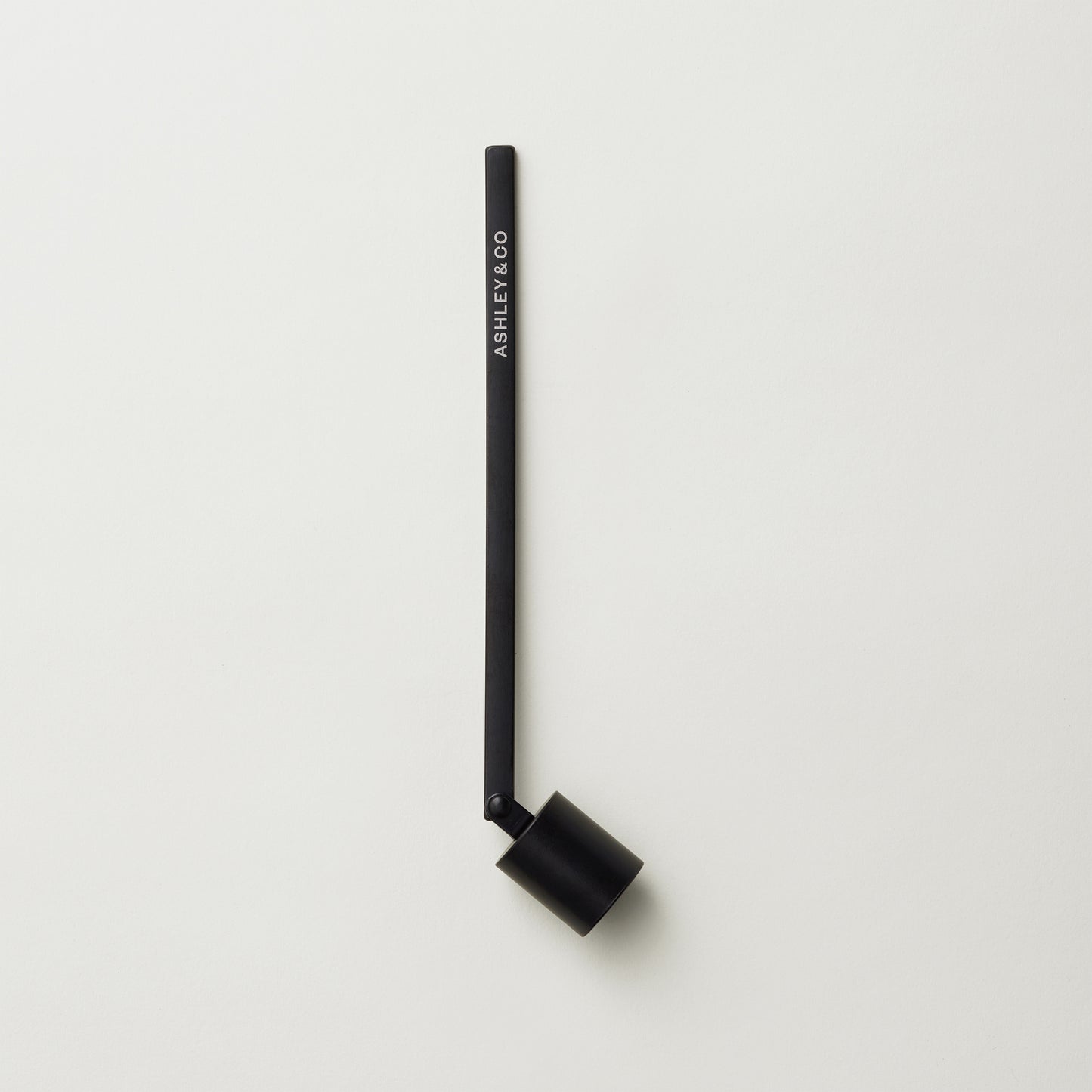 Ashley and Co "Snuffy' candle snuffer on a grey background.
