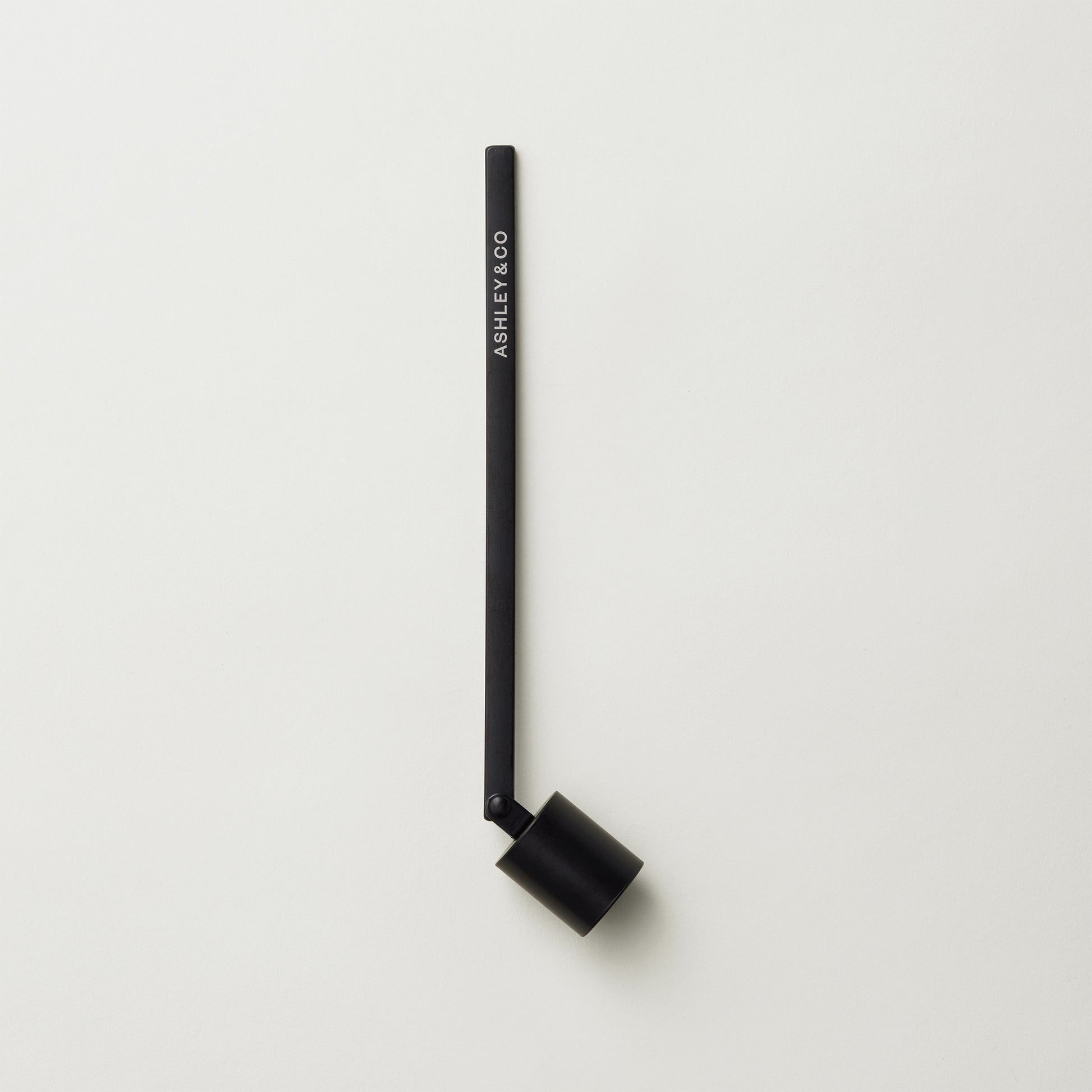 Ashley and Co "Snuffy' candle snuffer on a grey background.
