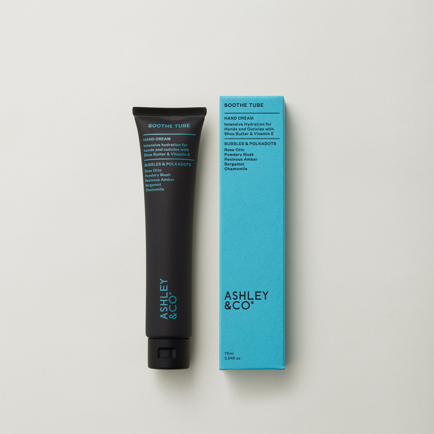 Ashley and Co 'Soothe Tube' handcream in bubbles and polkadots fragrance on a grey background.