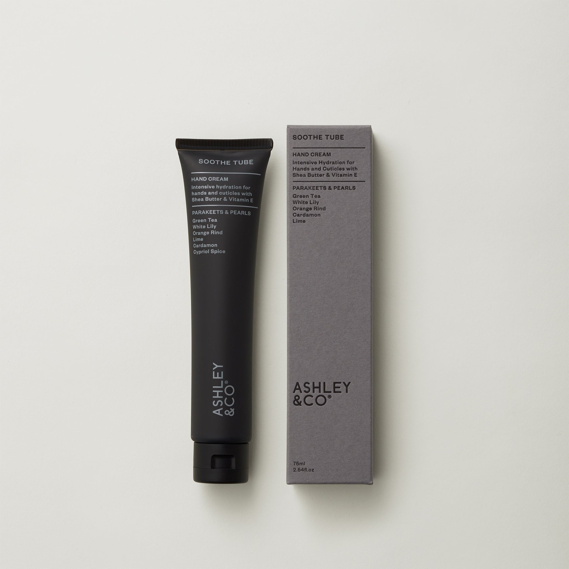 Ashley and Co 'Soothe Tube' handcream in parakeets and pearls fragrance on a grey background.