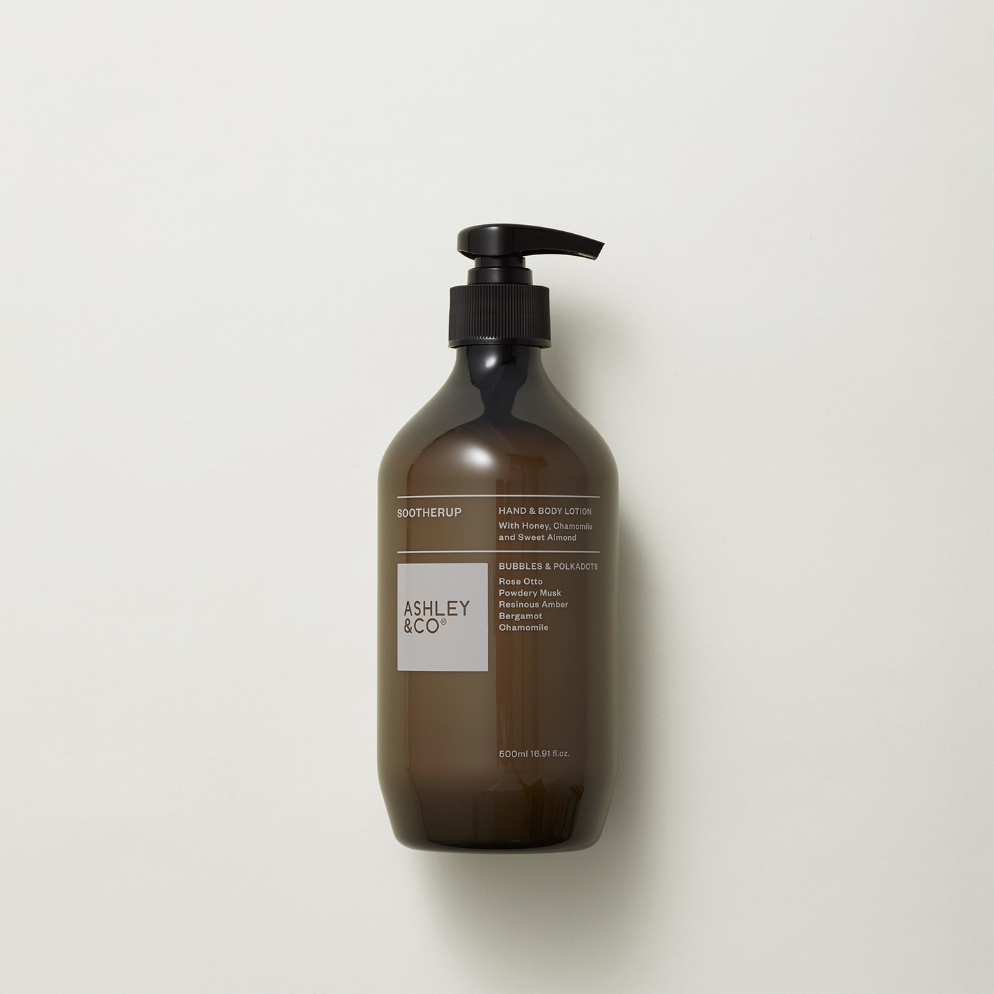 Ashley and Co 'Sootherup' hand and body lotion in bubbles and polkadots fragrance on a grey background.