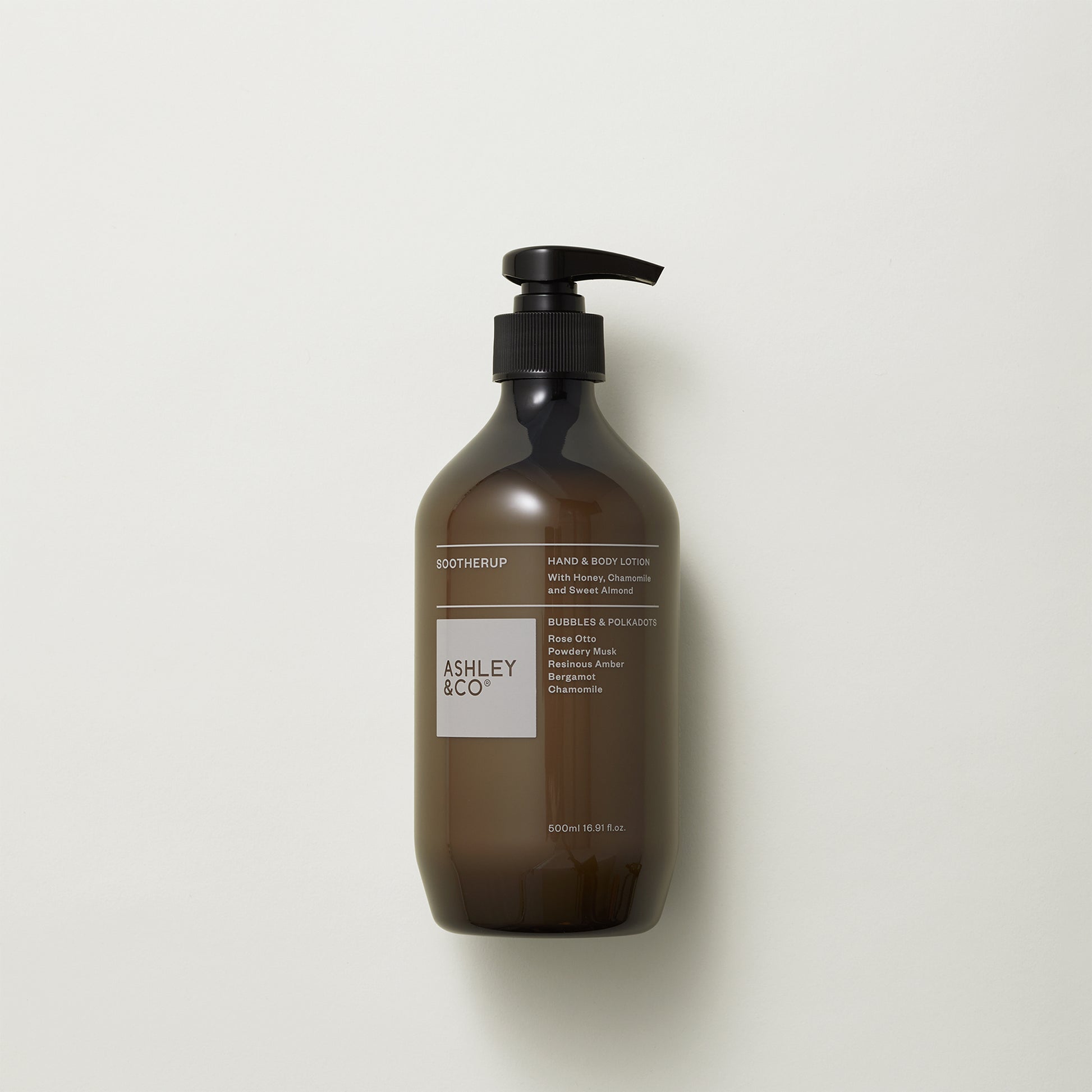 Ashley and Co 'Sootherup' hand and body lotion in bubbles and polkadots fragrance on a grey background.