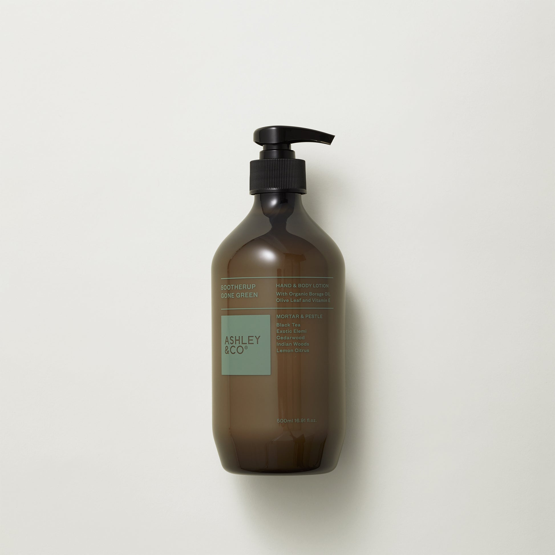 Ashley and Co 'Sootherup Gone Green' hand and body lotion in mortar and pestle fragrance on grey background.