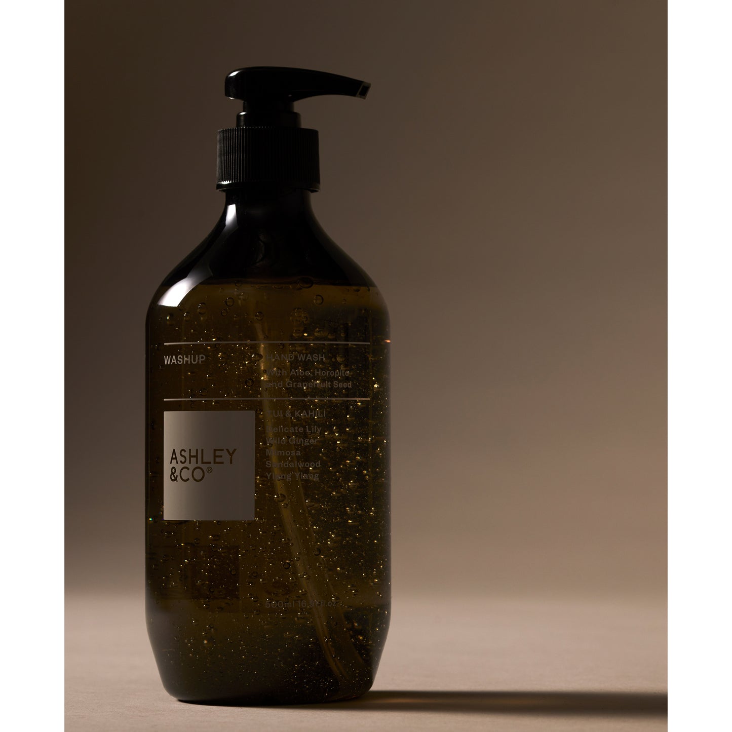 Ashley and Co 'Washup' handwash in Tui and kahili fragrance on grey background.