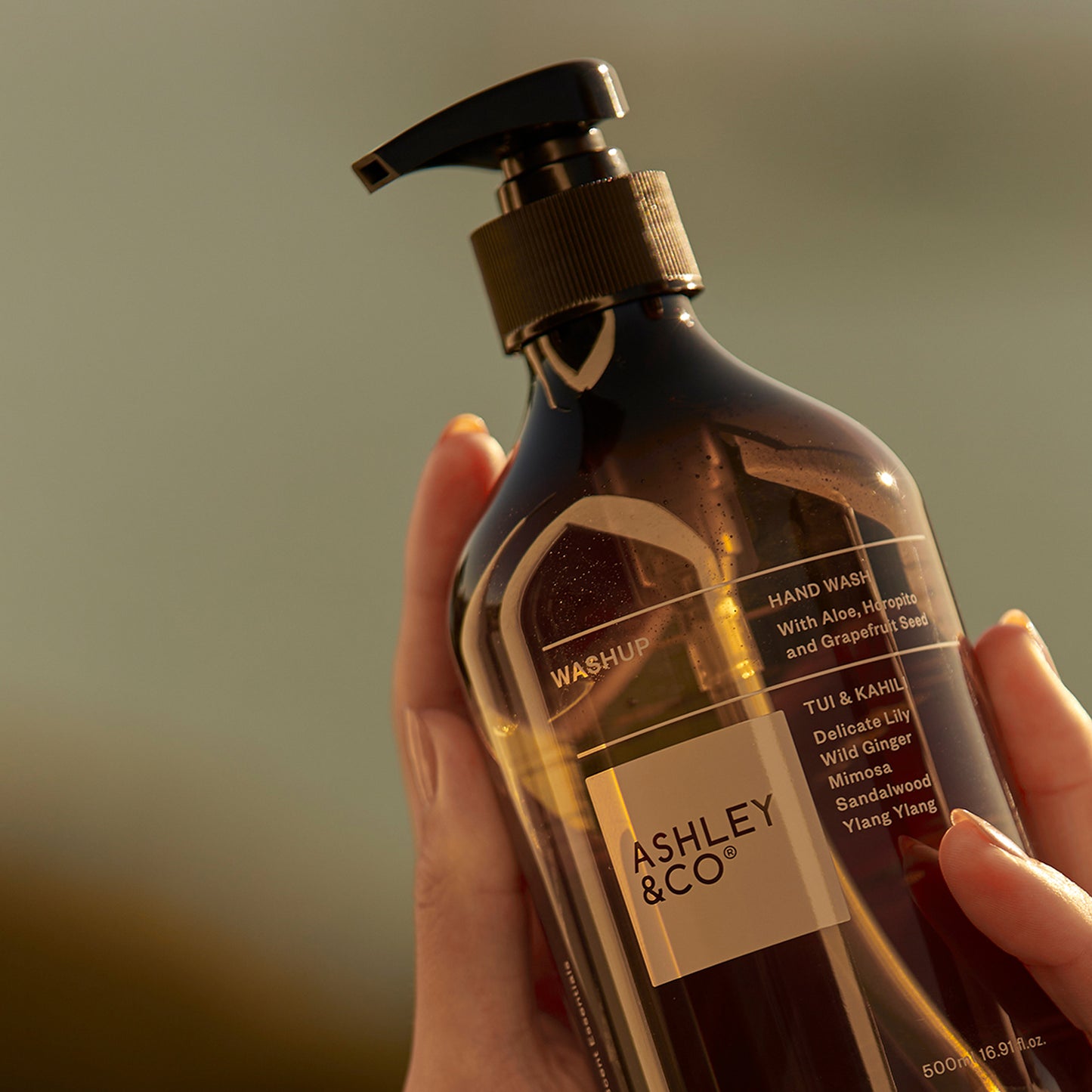 Ashley and Co 'Washup' handwash in Tui and kahili fragrance, hand held.
