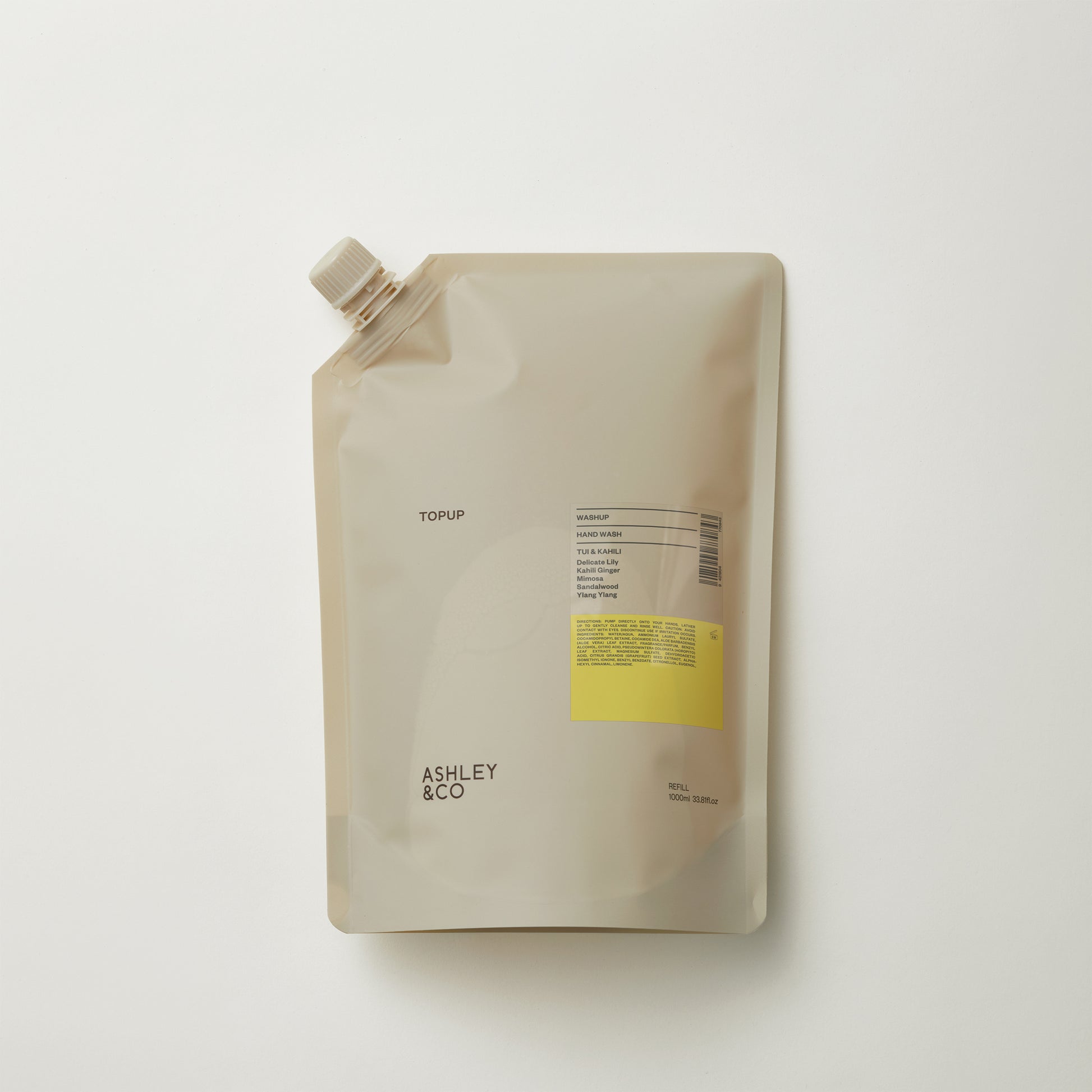 Ashley and Co 'Washup' handwash top up sachet in tui and kahili fragrance on grey background.