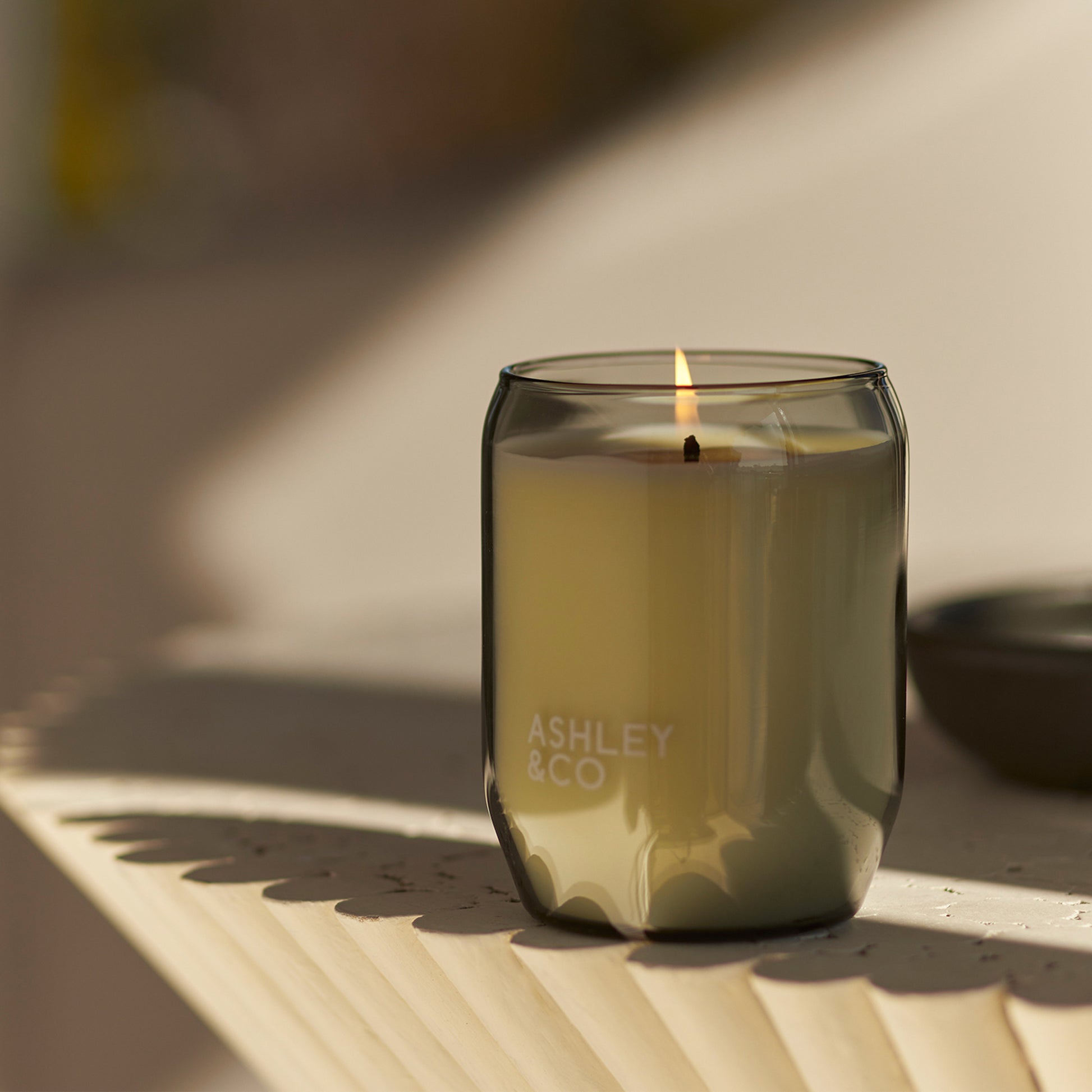 Close up of an Ashley and Co 'Waxed Perfume' scented candle burning in bubbles and polkadots fragrance.