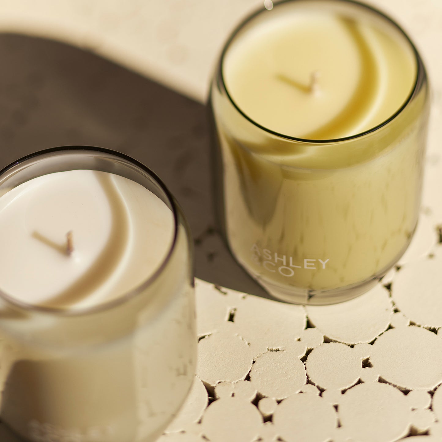 Close up shot of 2 Ashley and Co 'Waxed Perfume' scented candle in bubbles and polkadots fragrance.