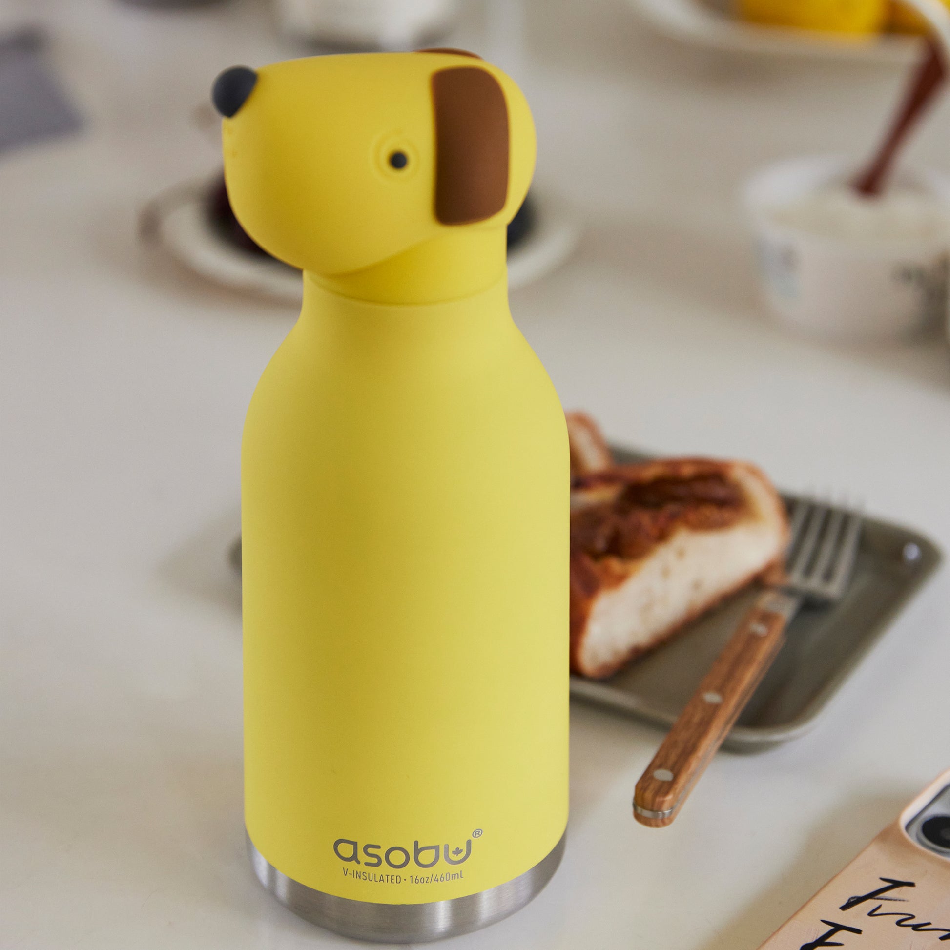 Dog Bestie water Bottle placed next to a a breakfast plate.
