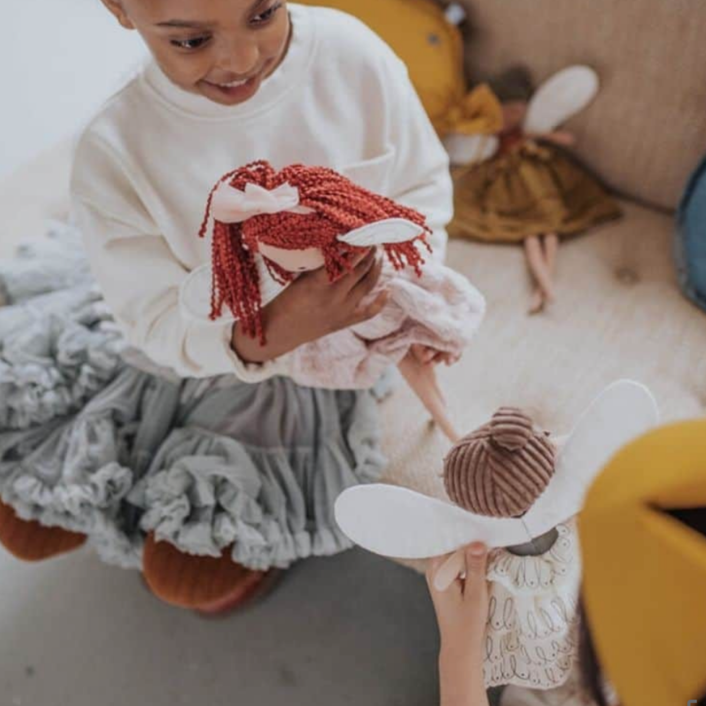 Young girls playing with assorted Bon Ton Toys with Celeste Fairy 35cm Pink plush toy in bedroom lifestyle shot