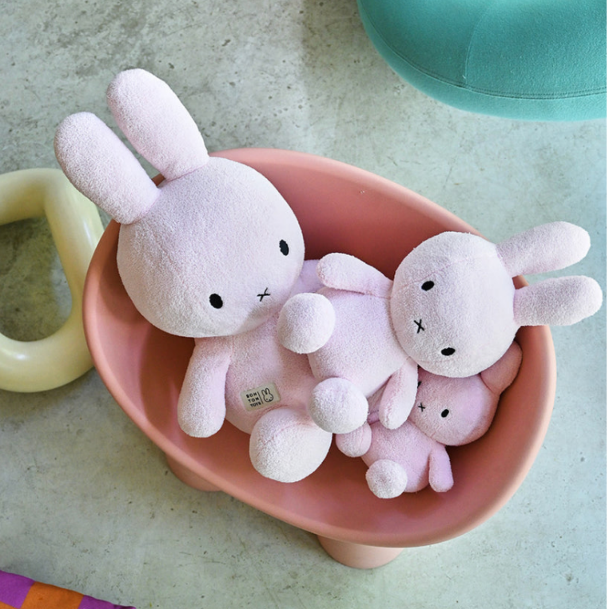 Pink tub of assoretd sizes of light pink terry Bon Ton Toys Miffys lifestyle shot