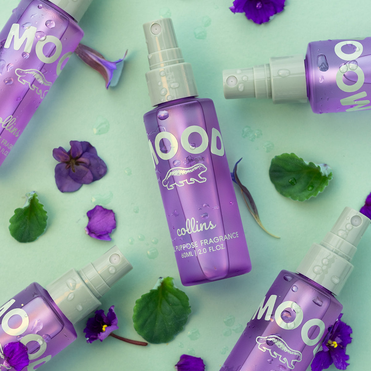 Flat lay shot of many bottles of travel sized mood water by collins in french violet scent.