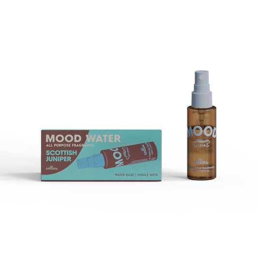 A travel sized bottle of scottish juniper scented mood water by collins, placed next to its box.