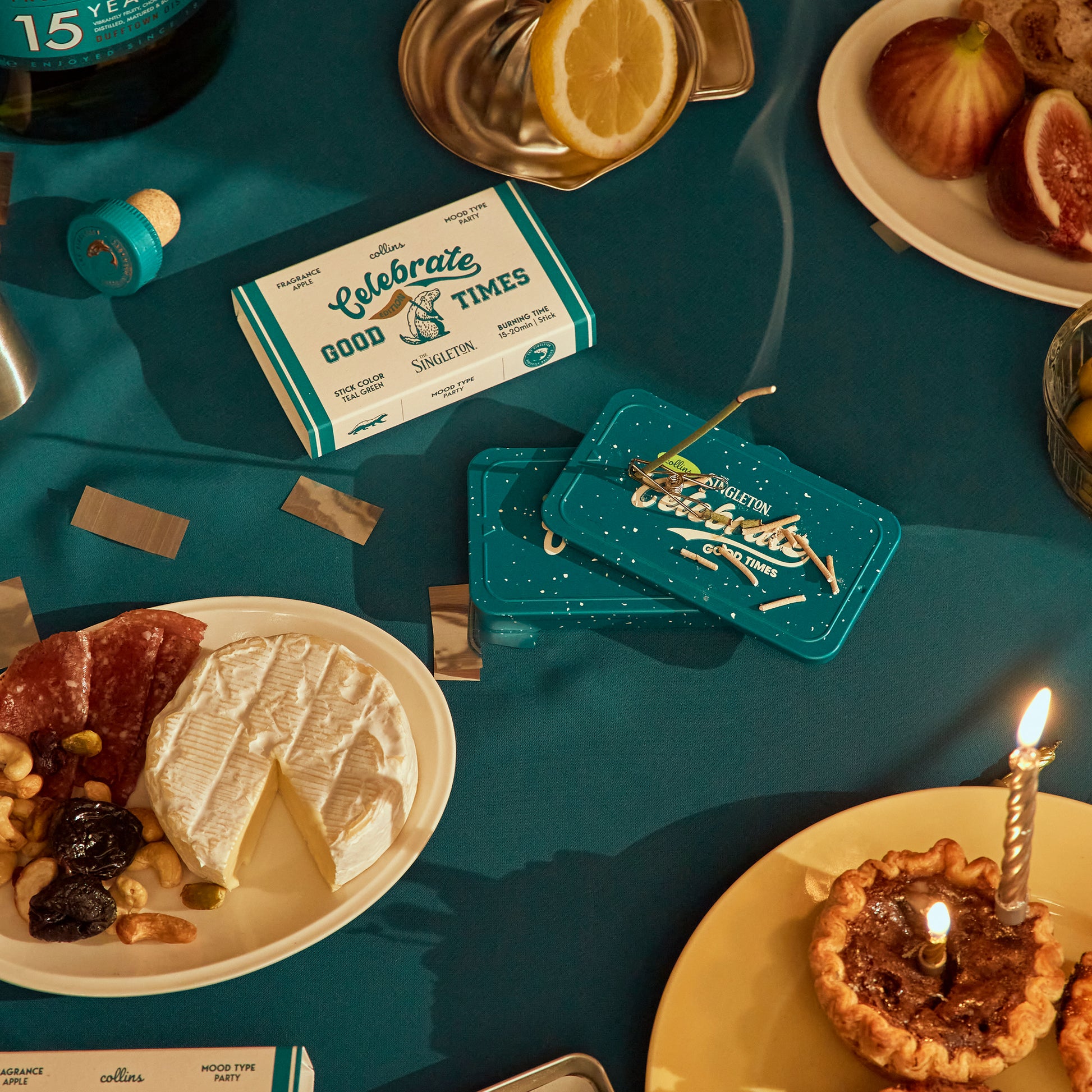 An flat lay shot featuring tin of Collins natural incense sticks in good times scent on a dining table during dessert.