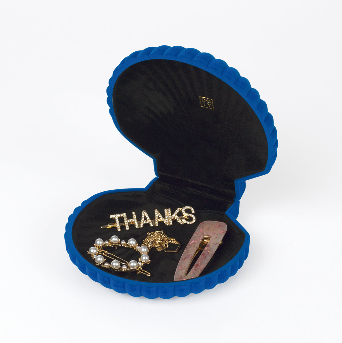 Open DOIY blue velvet venus jewelry box filled with jewels on white background