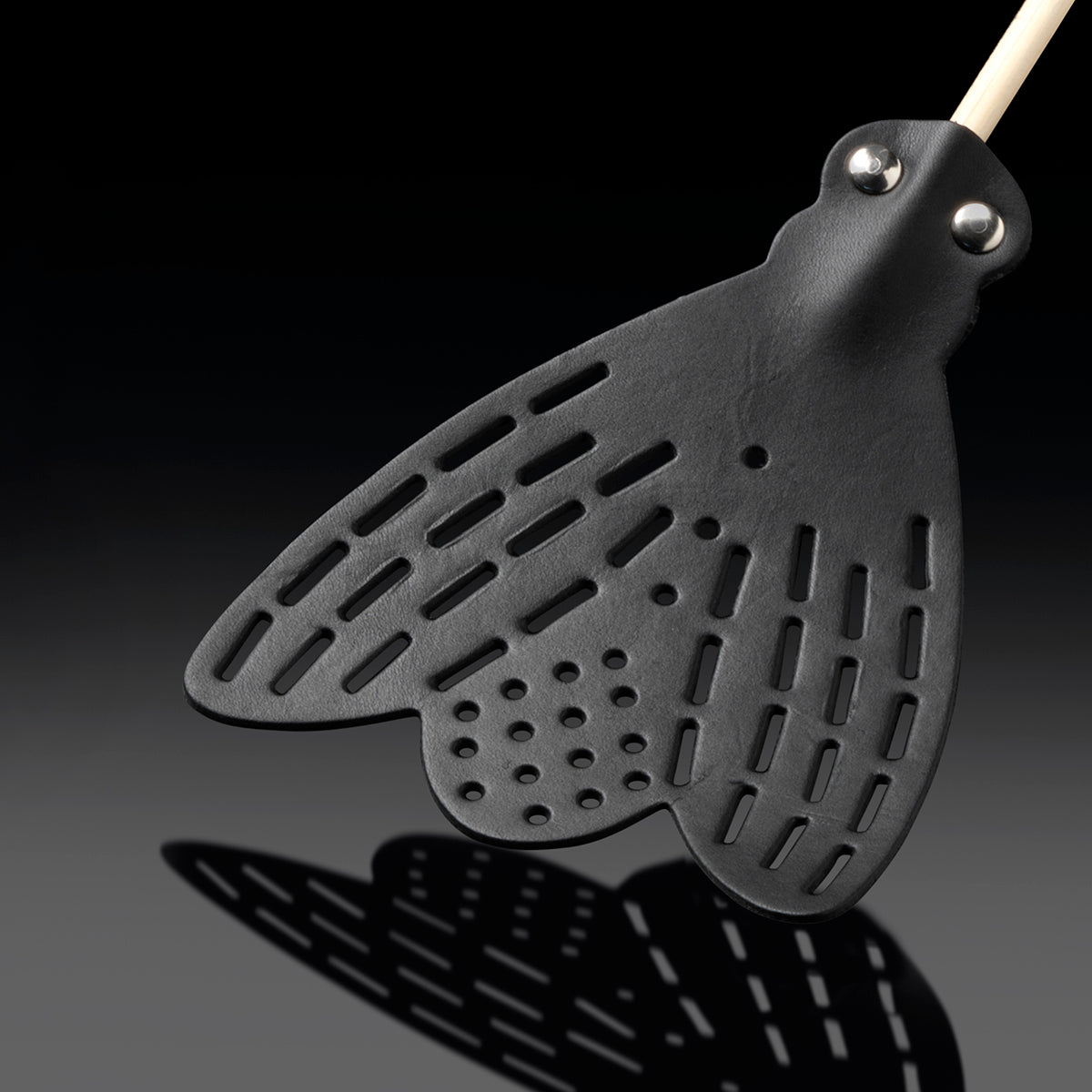 Close up of Essey fly-fly black swatter head on angle on black background