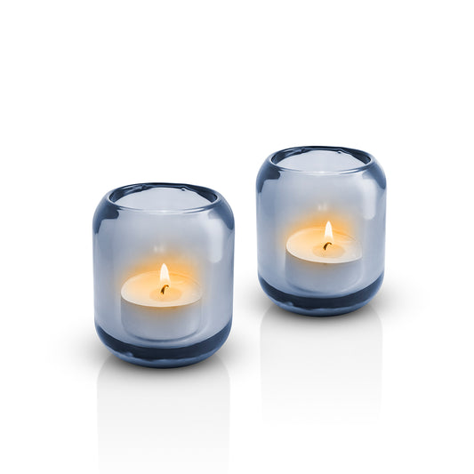 Pair of Eva Solo glass Acorn tealight holders in Sea blue, with lit candles inside 