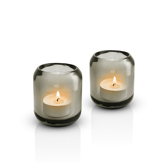 Pair of Eva Solo glass Acorn tealight holders in Stone, with lit candles inside 