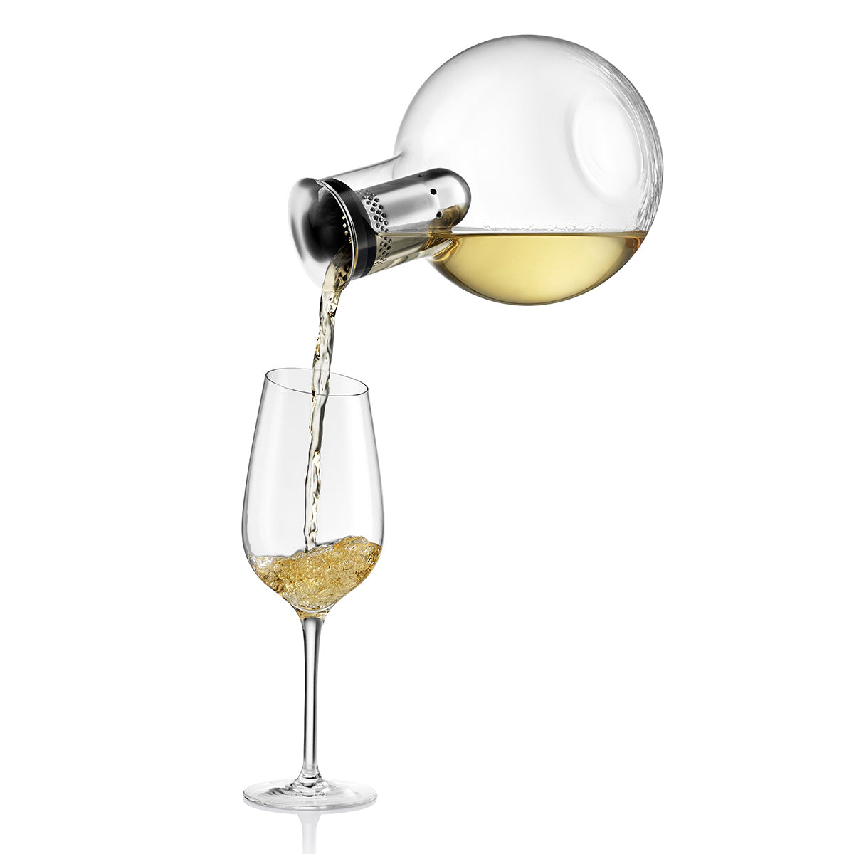 White wine being poured from Eva Solo's Cool Wine Decanter into a wine glass.