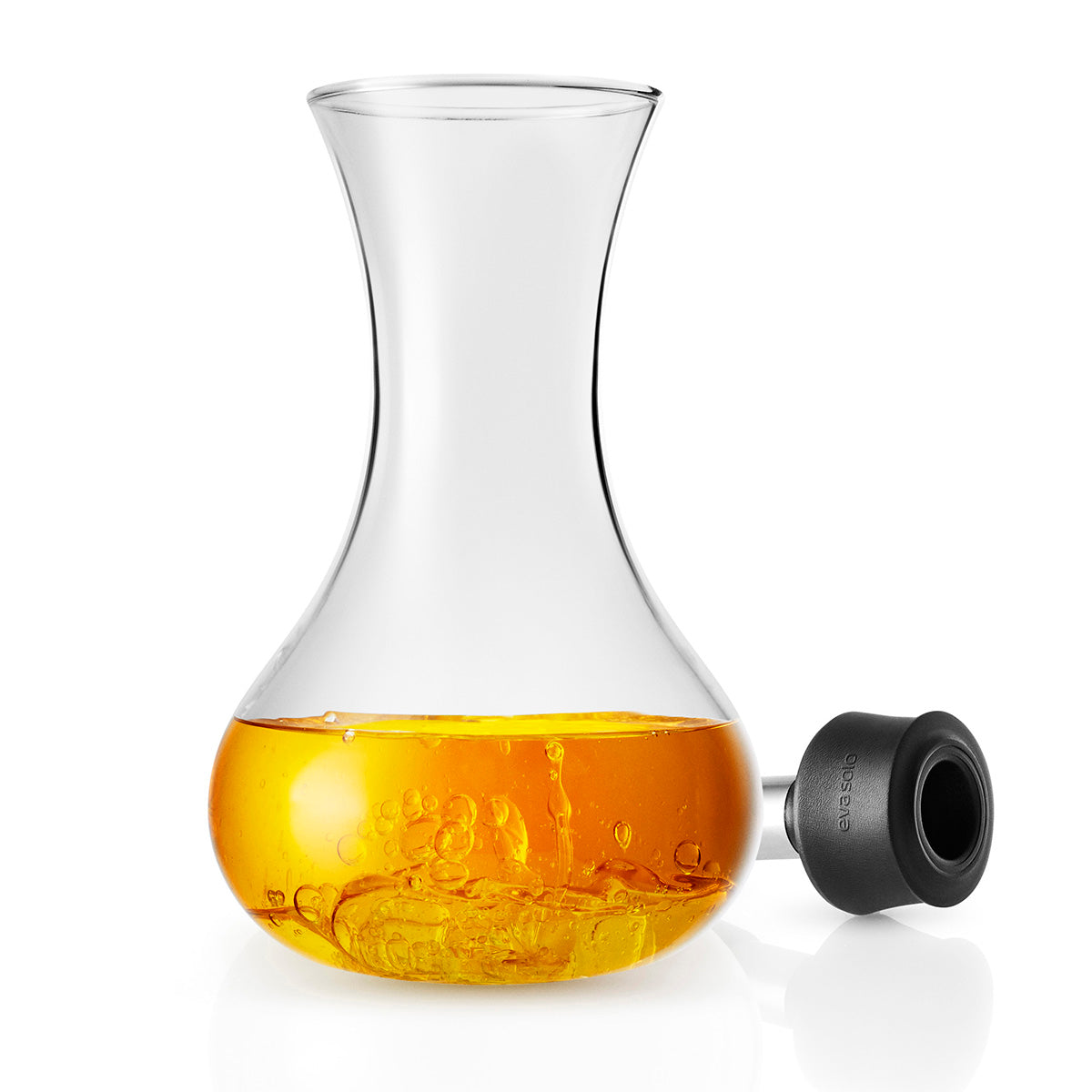 Oil inside the open Eva Solo dressing shaker - clear glass bottle, transparent food-safe container for mixing and storing salad dressings, oils, and liquid seasonings.