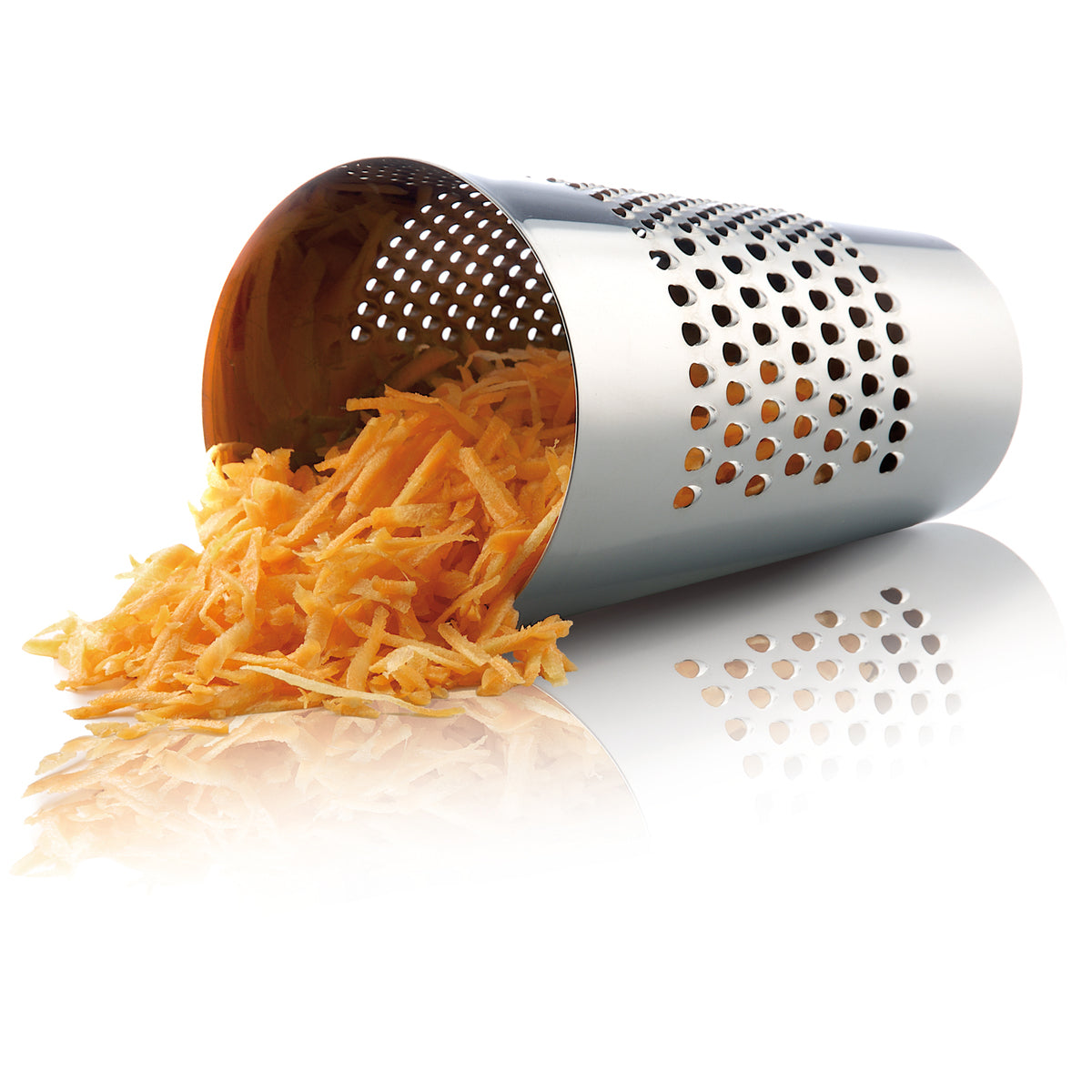 Laid on the table Eva Solo grating bucket with the grated carrots inside- stainless steel kitchen grater in silver color, cylindrical design for grating vegetables, cheese, and chocolate directly into the bowl.