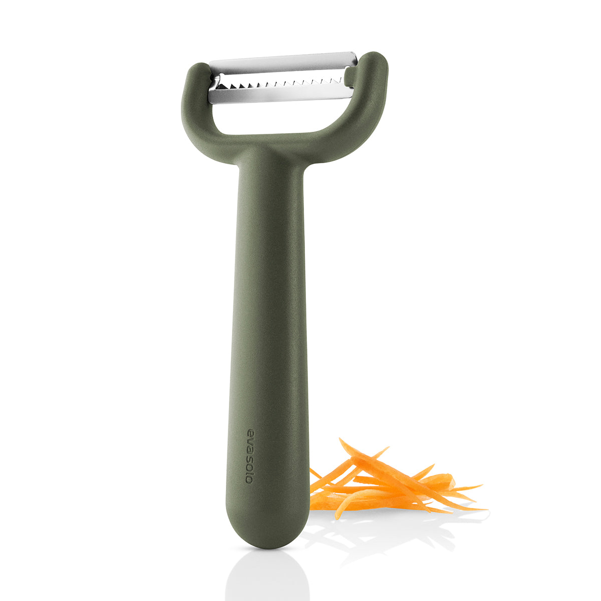 Eva Solo green tool Julienne Peeler standng upright with julienned carrot.