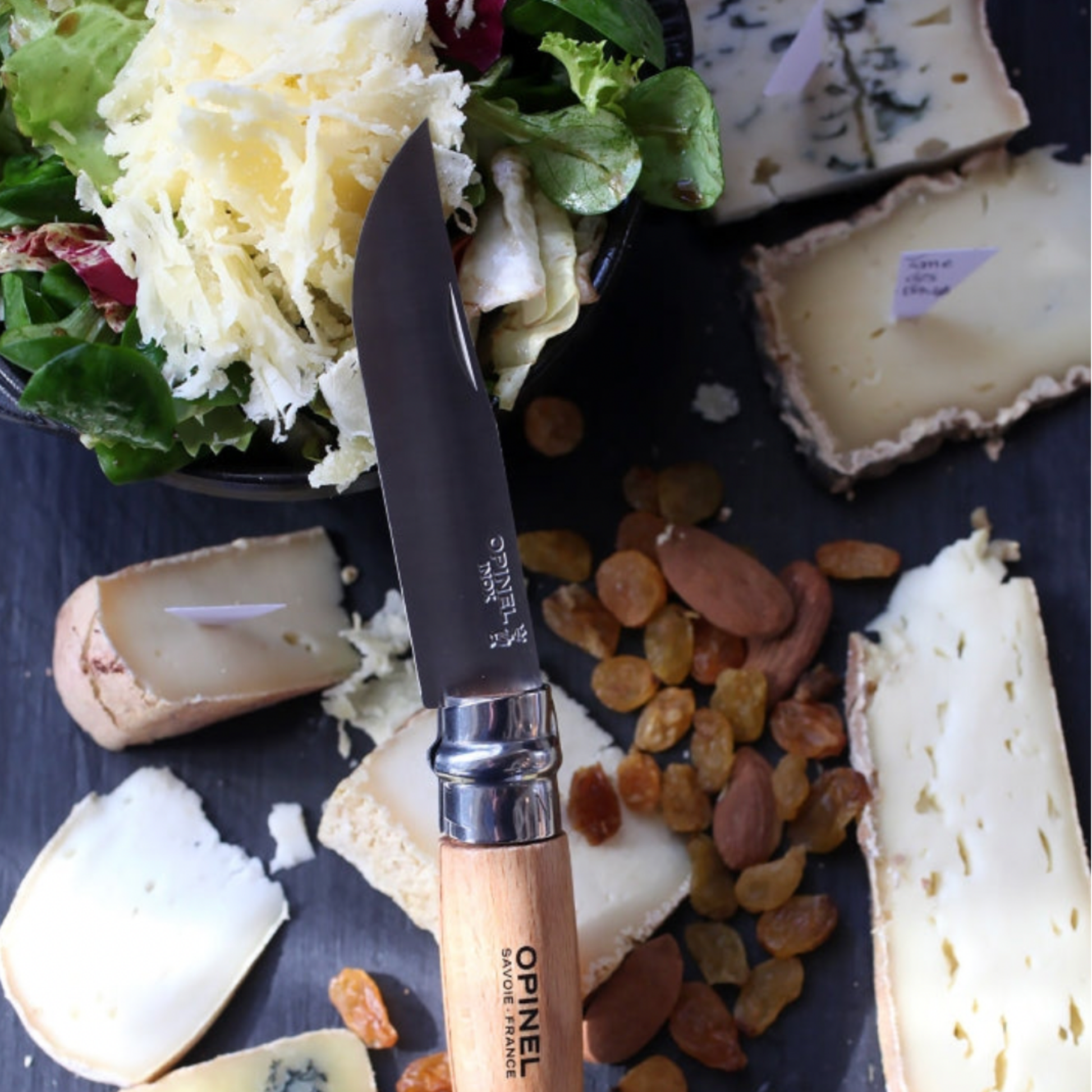 One of Opinel folding knife 10pc Set on cheese board 