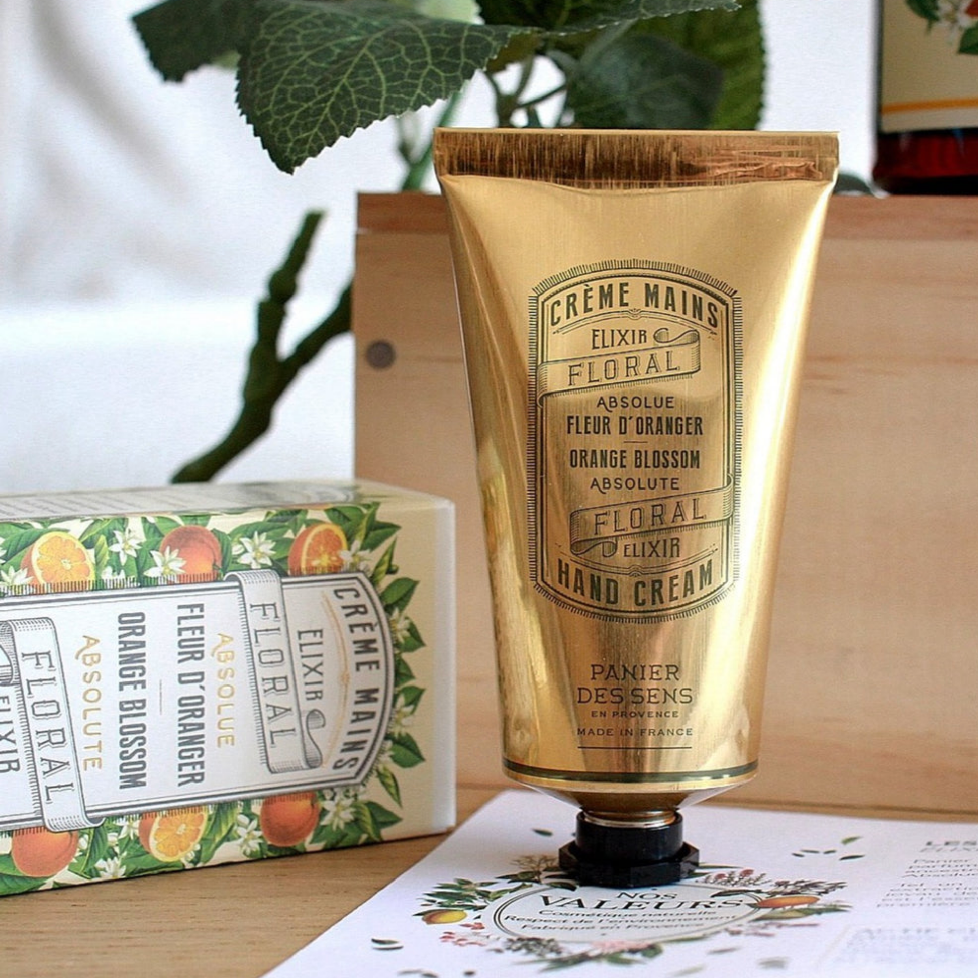 Panier Des Sens Hand Cream 75ml Orange Blossom on table with box infront of of plants