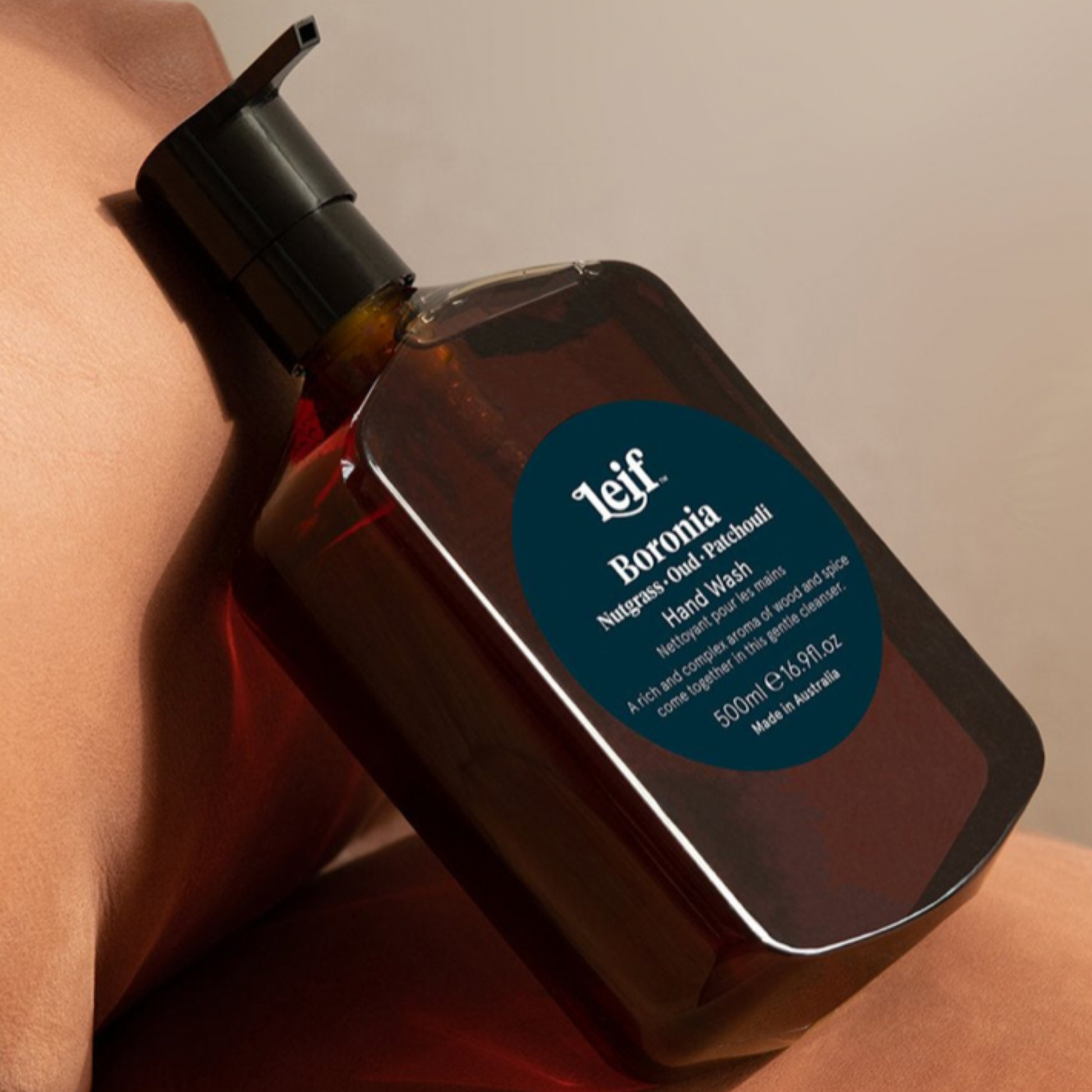 Close up of Leif hand wash 500ml Boronia on neutral tonned couch 