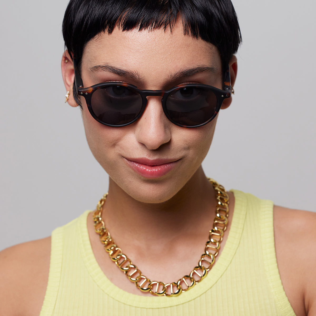Close up of man wearing Izipizi shape d tortoise sunglasses on an angle