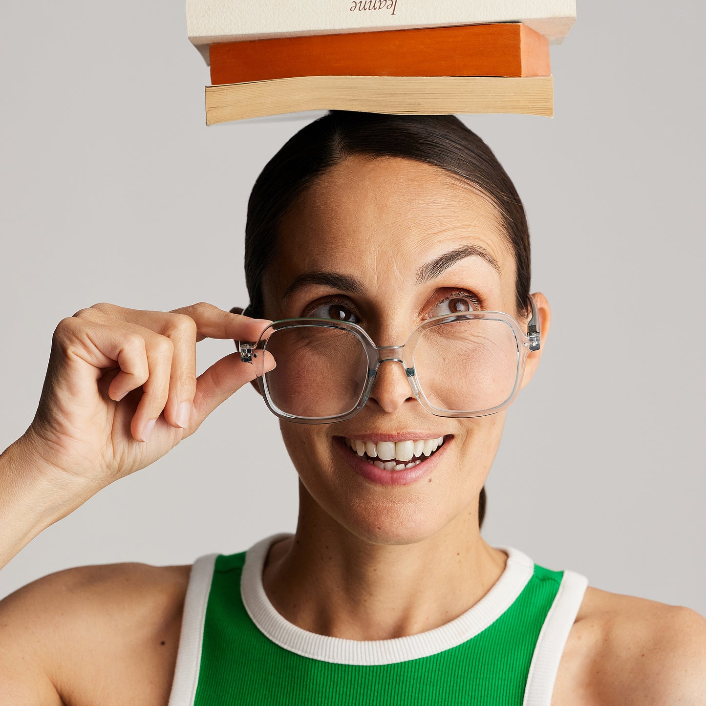 Front view of a woman wearing IZIPIZI Reading Collection O Frozen Blue reading glasses made from eco-friendly bio-sourced polyamide with flexible spring hinges and soft-touch texture - lightweight unisex eyewear in an oversized square design.