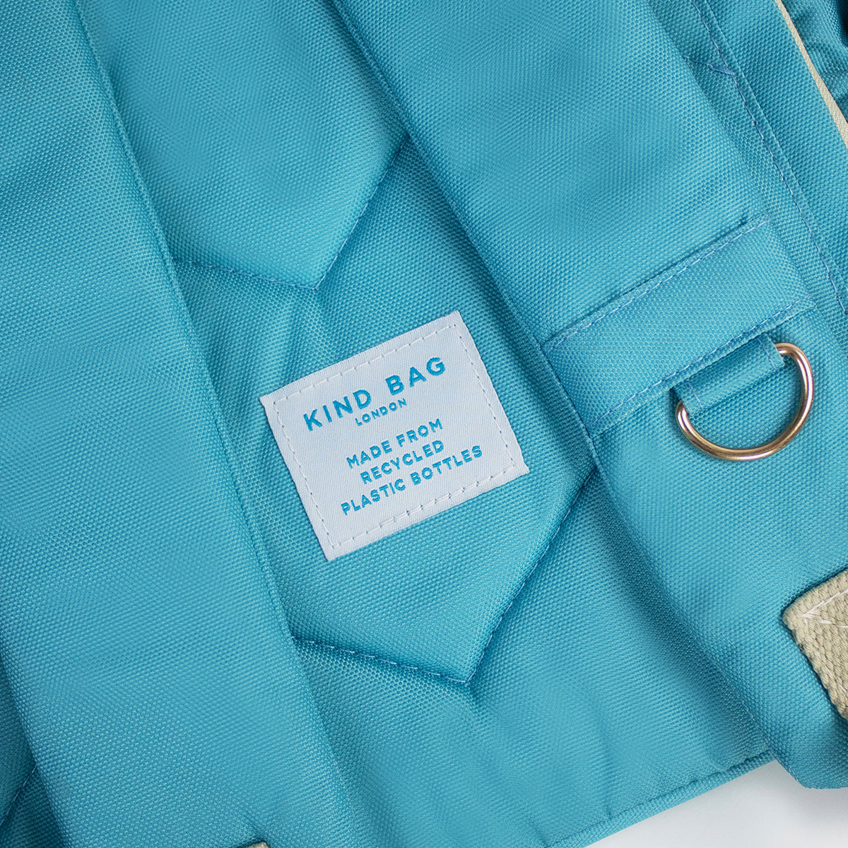 Kind Bag's Backpack Medium in colour teal showing the tag on the back.