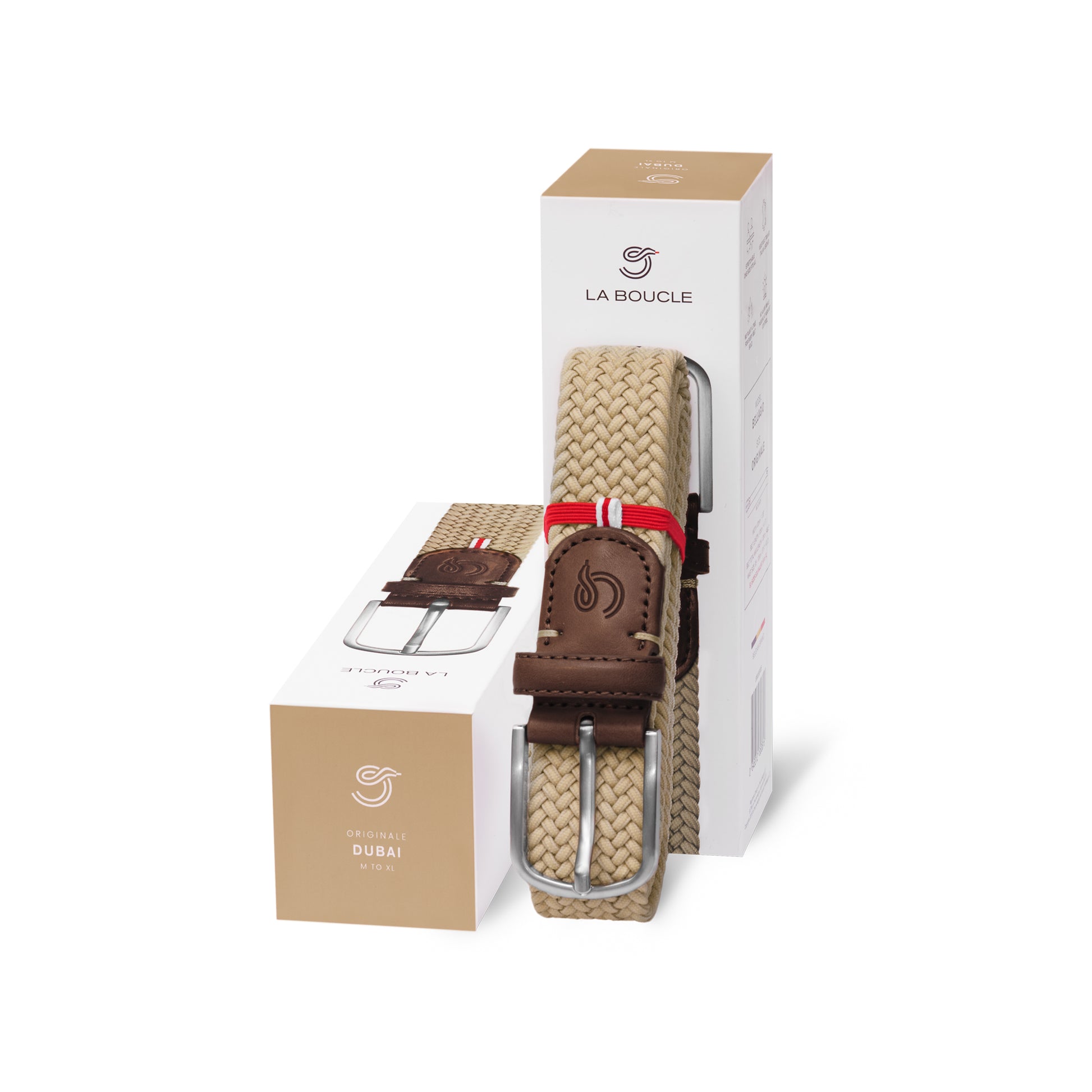 La Boucle mono dubai woven belt folded and leaning on a box next to a box on white background